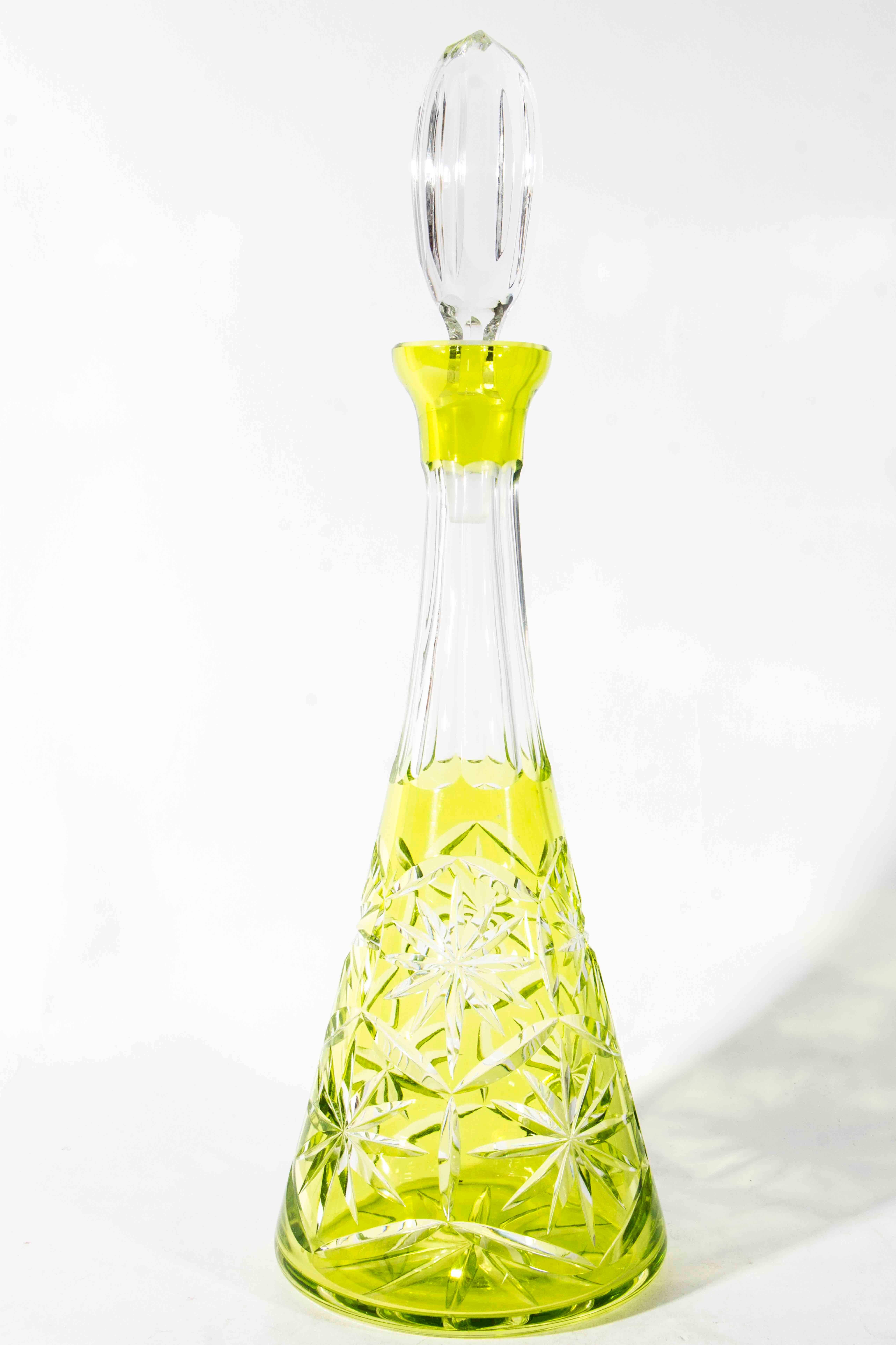An antique Saint Louis lime decanter set. The set include lime decanter with clear cut crystal topper. Six lime wine glasses with clear stem. The decanter measure 16 inches high x 6 inches diameter. The glasses measure 7 inches high x 3 inches