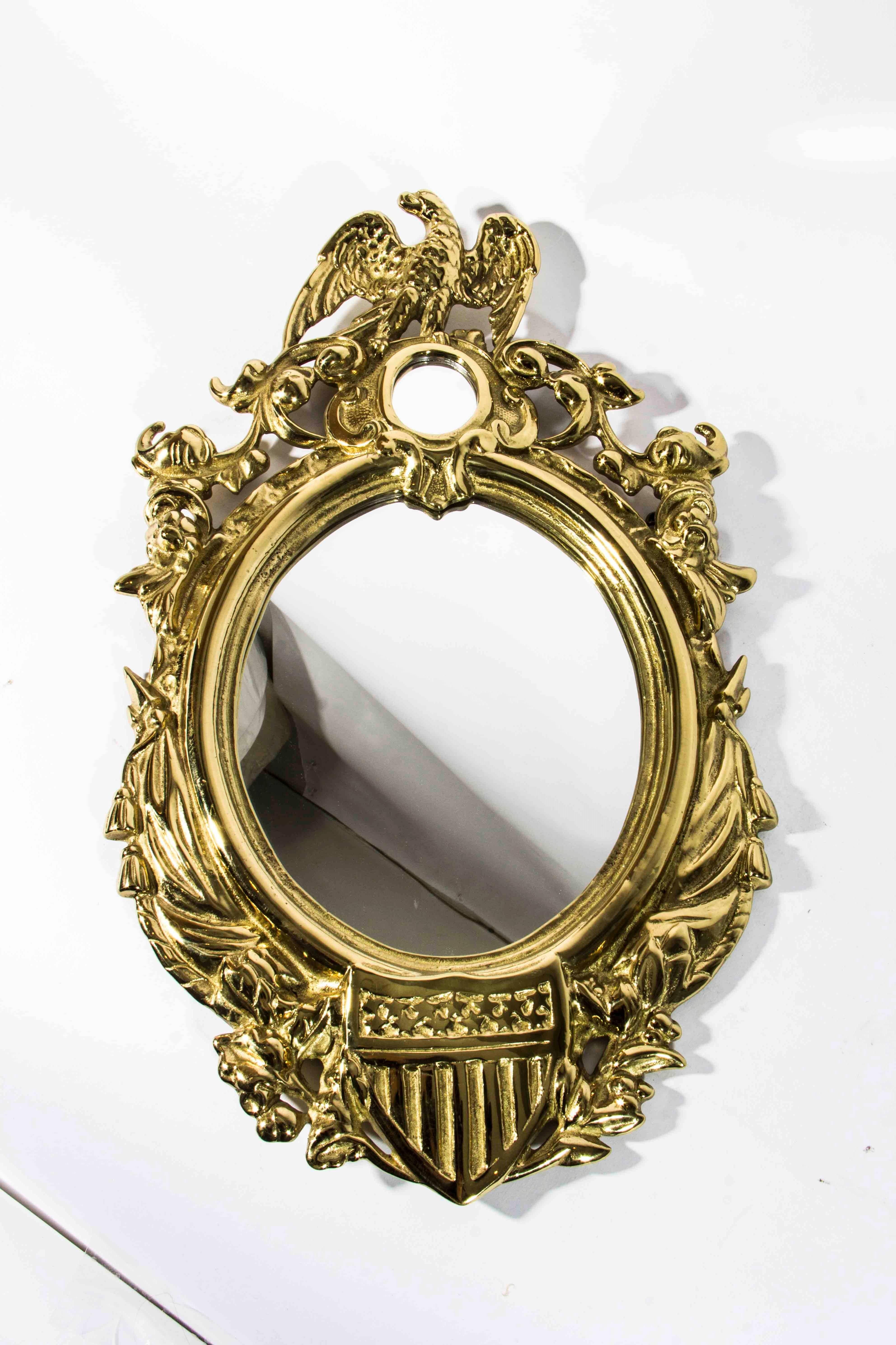 Antique Solid Brass wall Mirror. Excellent Condition. Frame is original . Mirror was replaced in the 1950's. It only measure 19 Inches Long X 11 Inches width.
