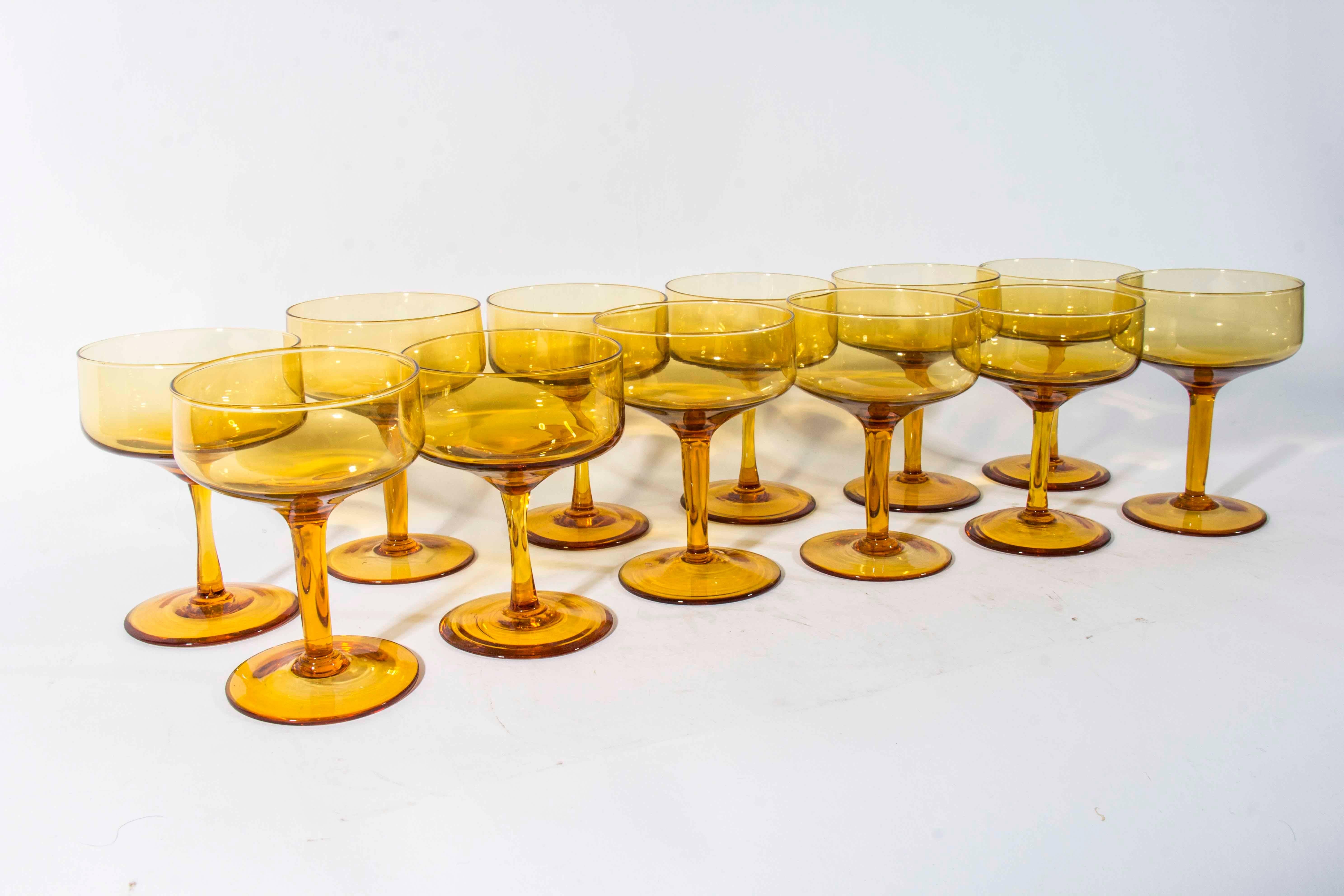 Vintage set of 12 amber champagne coupe. Excellent condition. The champagne coupe measure 5 inches high X 4 inches diameter.