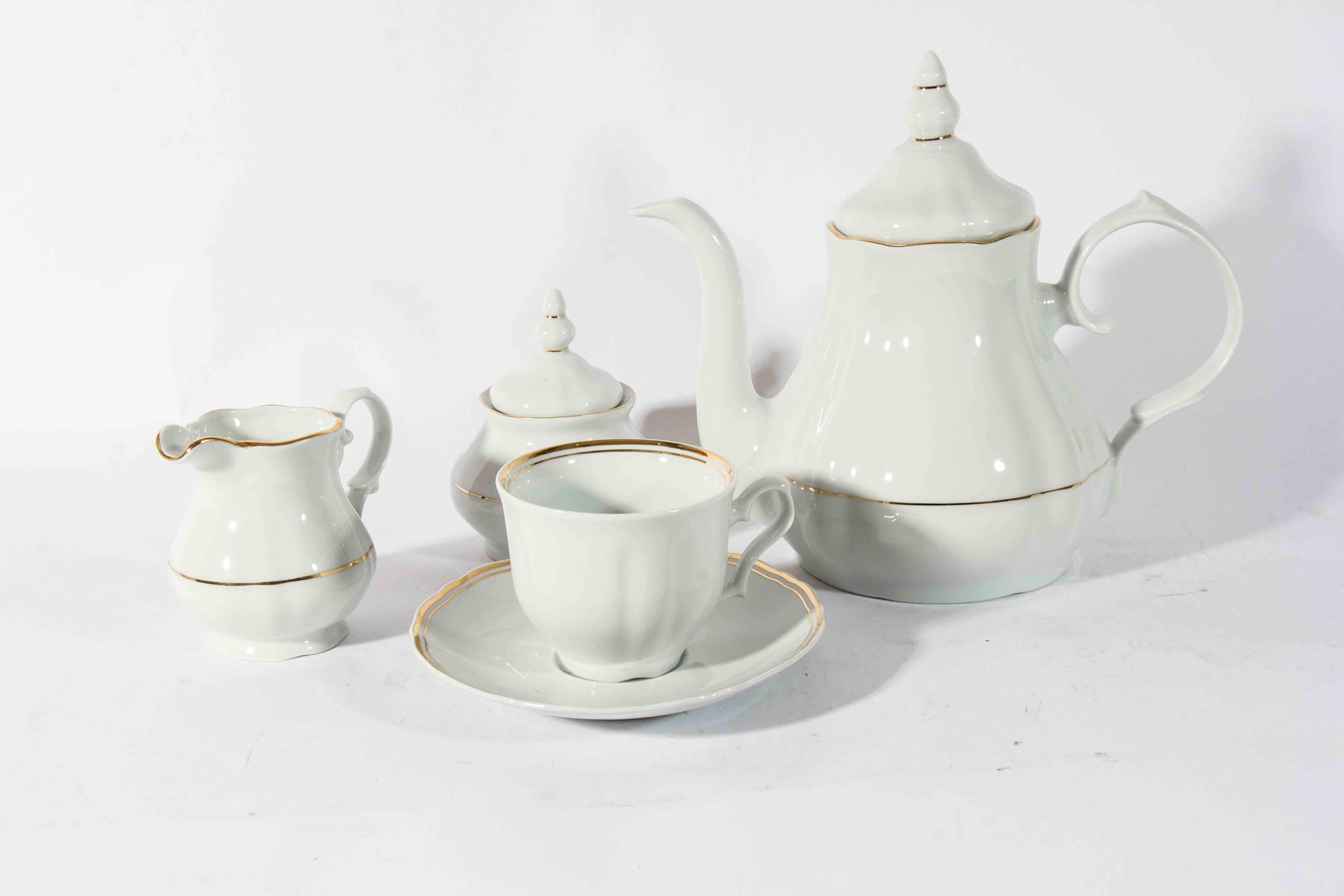 Vintage white porcelain with 24-karat gold trim coffee or tea service for six people. Excellent condition. The tea or coffee pot measure 8 inches high x 9 inches diameter. 17 pieces set.