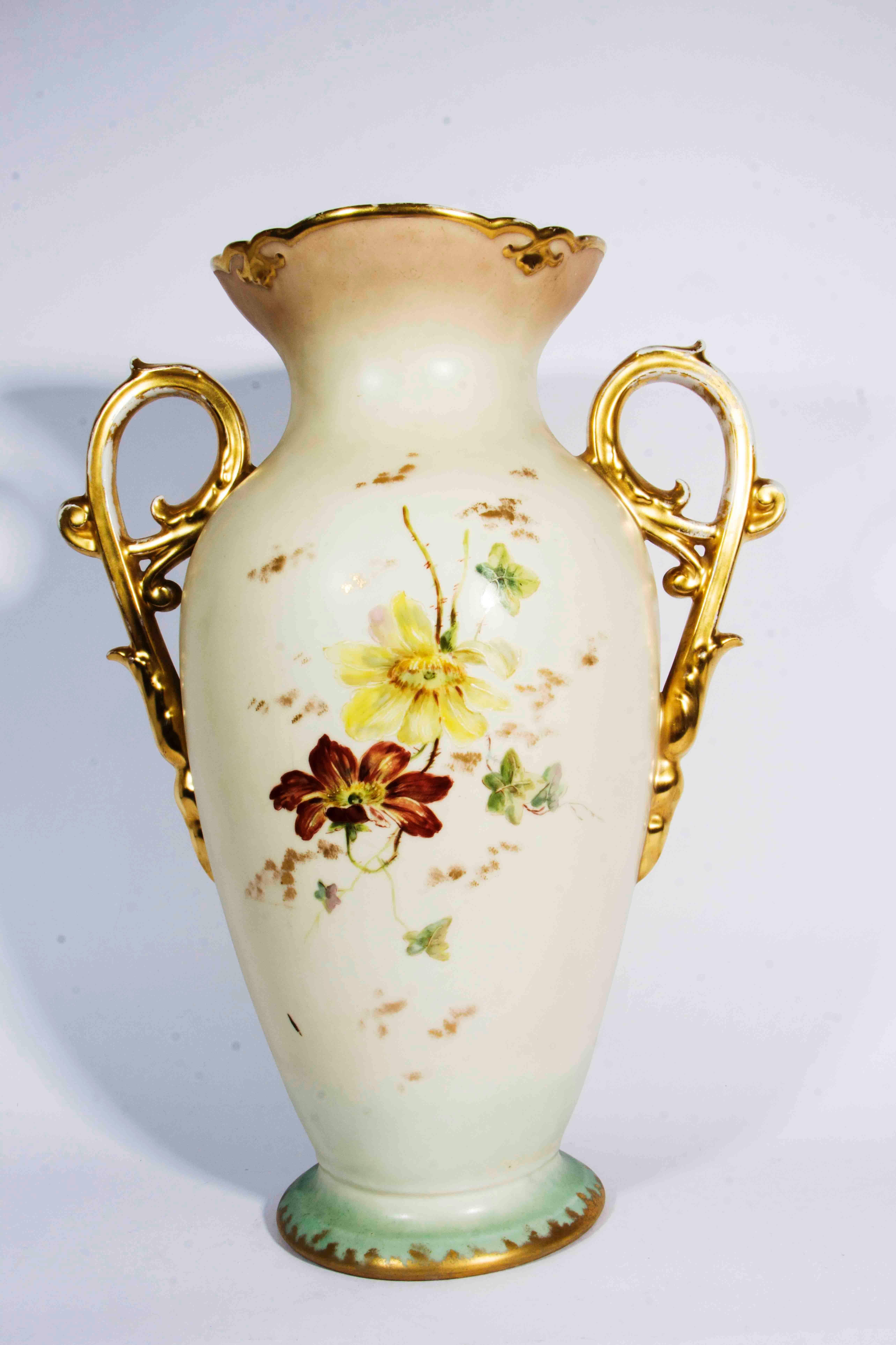Antique French porcelain decorative vase / piece with gold handle. The vase measure 16 inches high x 11 inches diameter.