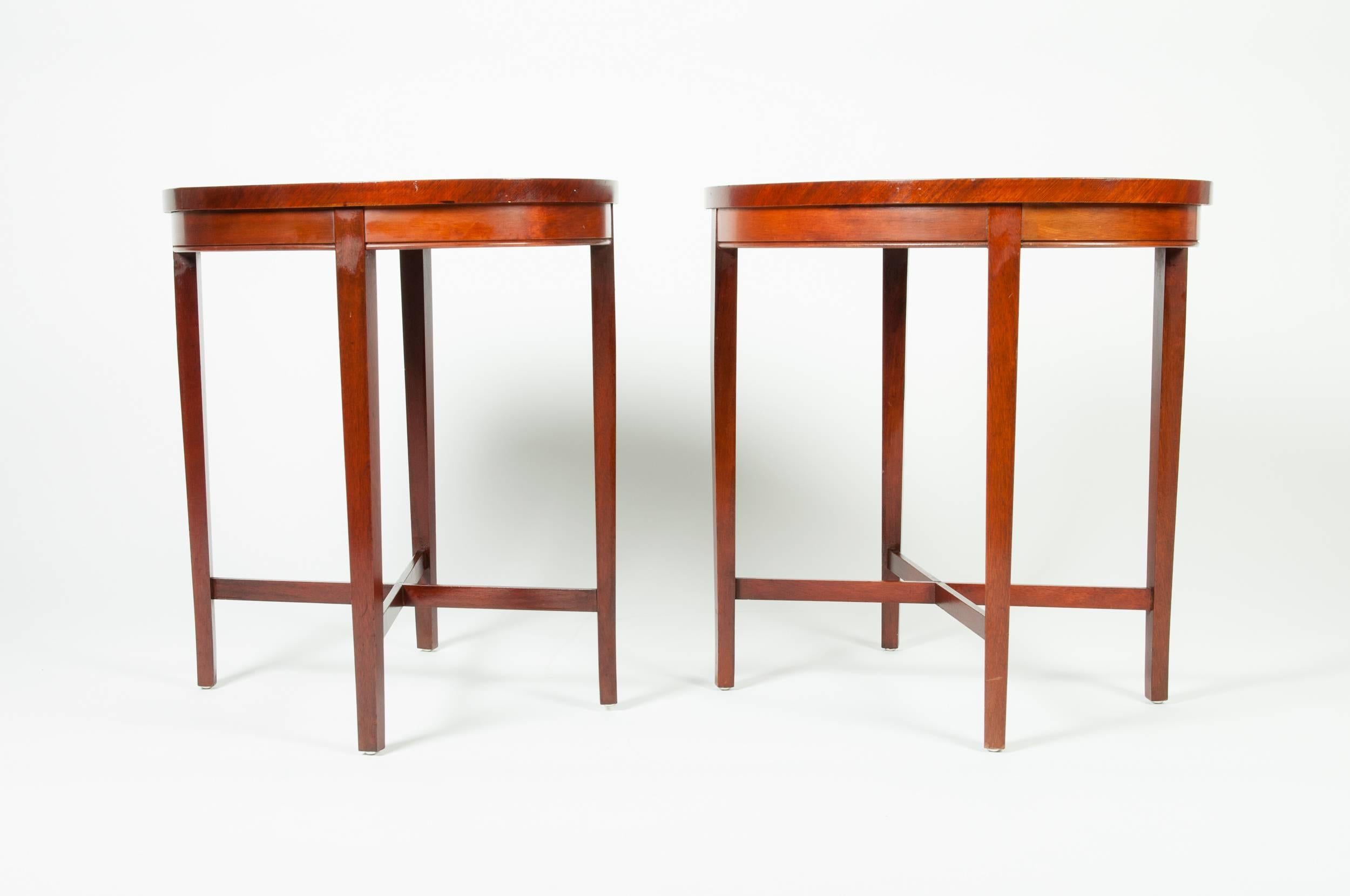 Vintage pair of mahogany wood oval side tables. The table's measures 23 inches high x 22 inches long x 22 inches width.