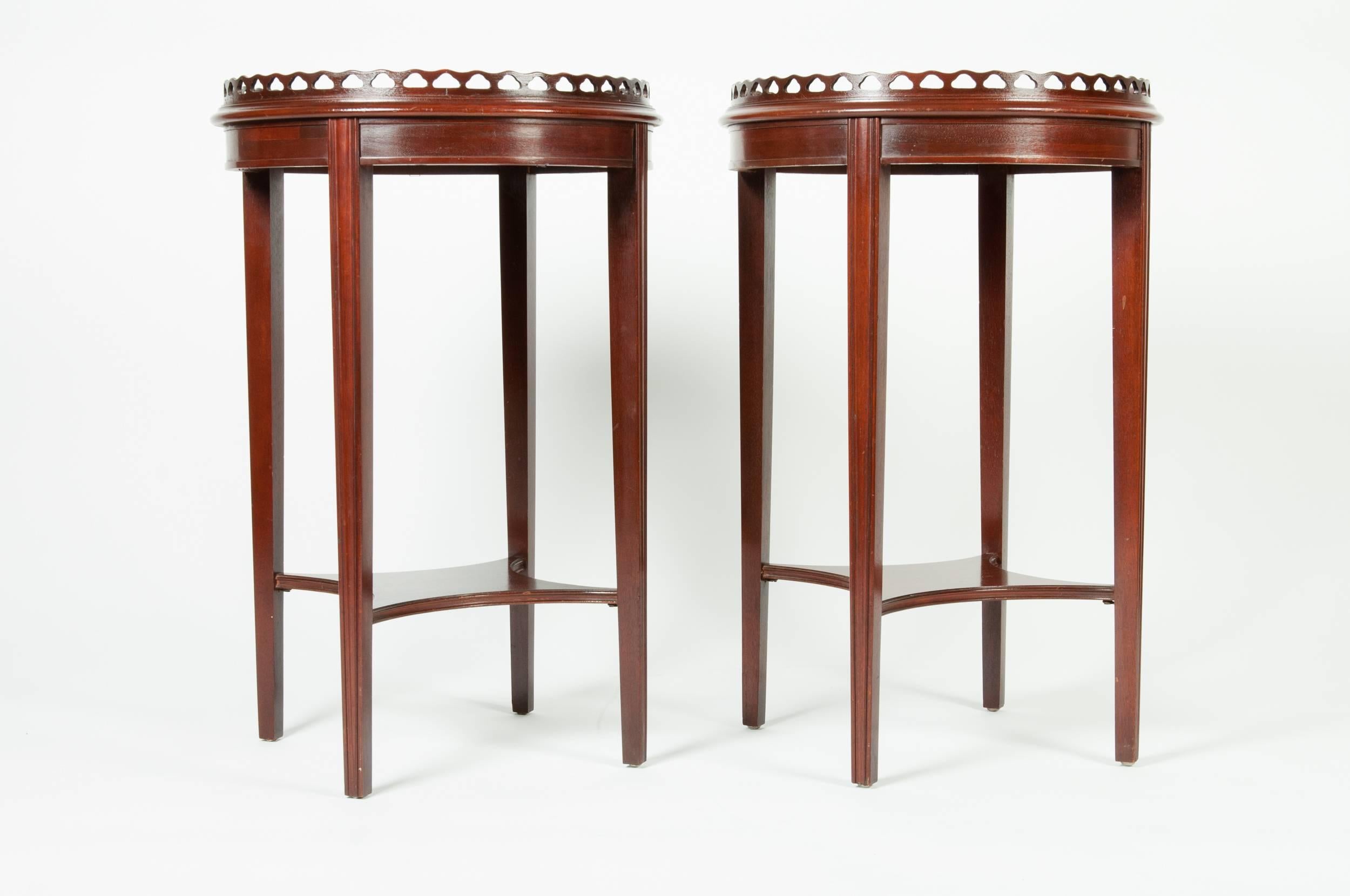 Antique pair of mahogany wood side/end tables with top round gallery tray. The tables measure 27 inches high x 17 inches in diameter.