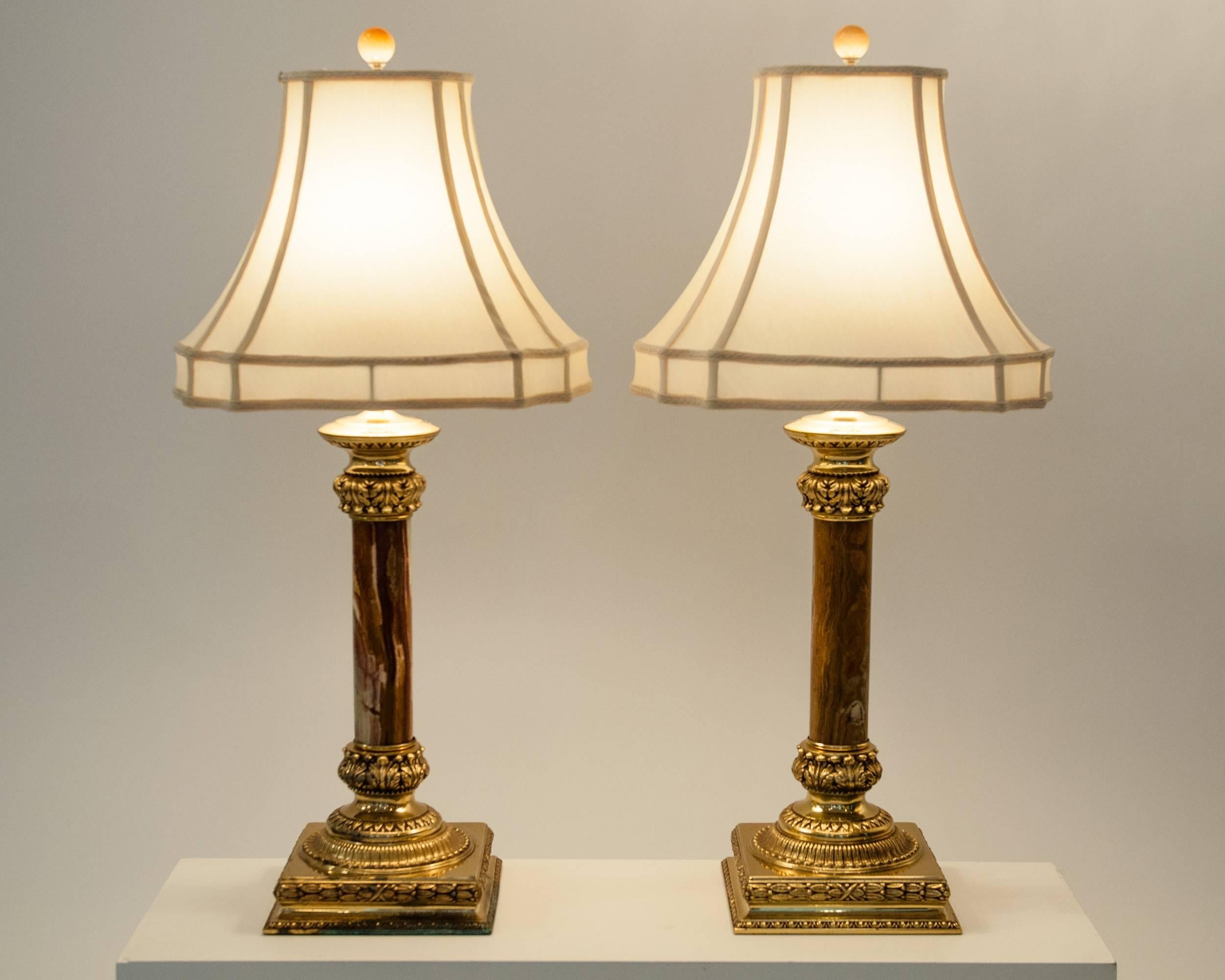 Antique pair of Jade table lamps with solid brass base with design details. The lamps come with 100% silk bell shade. Each lamp measure 34 inches high x 7.5 inches width base. Each shade measure 6