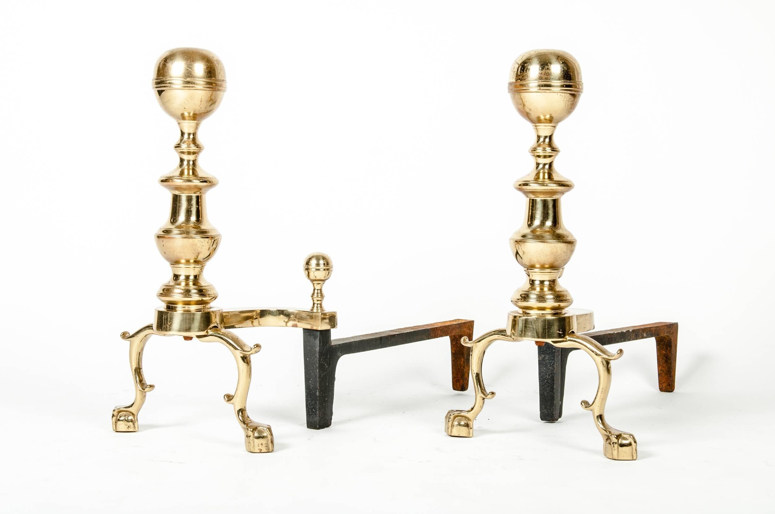 Vintage pair of solid brass English andirons. Each andiron measure 17 inches high x 21 inches long.
