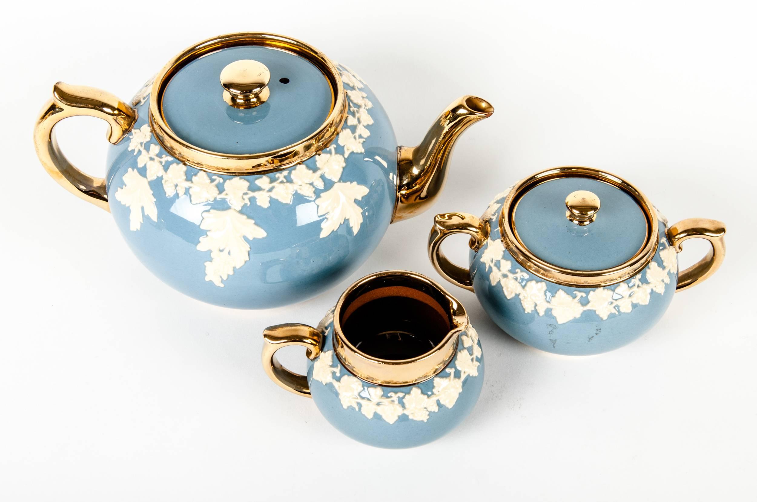 Vintage English glazed ceramic tea service. The tea pot measure 9.5 inches width x 5 inches high. The sugar bowl measure 6 inches width x 3 inches high. The creamer measure 4 inches width x 2.5 inches high.