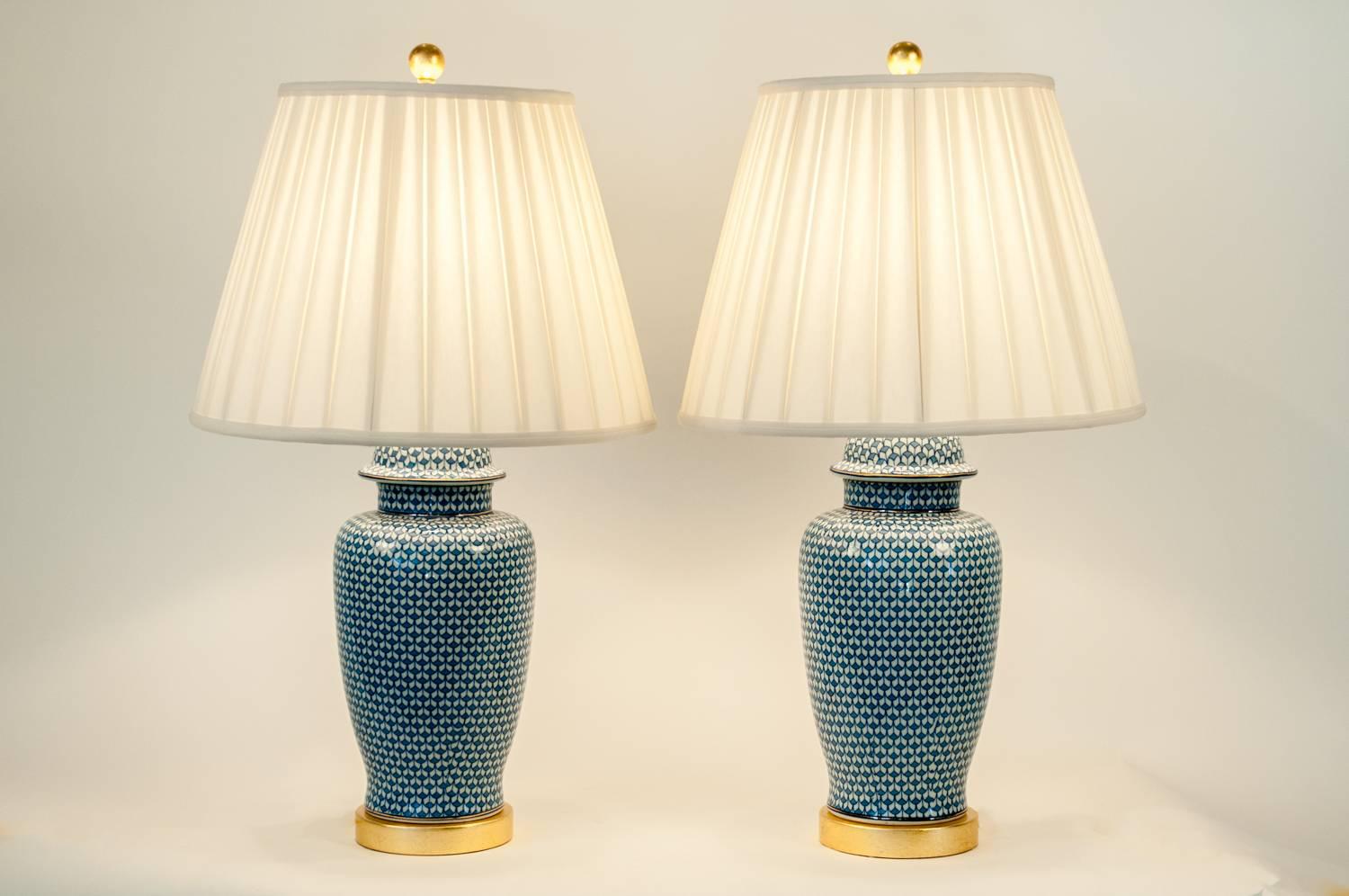 Pair of goyard porcelain ginger jar lamps with gold-plated base. No special lights bulb required. The lamps come with round pleated bell silk shade. Each lamp measure 32 inches high x 6.5 inches diameter. Each shade measure 14 inches long x 11