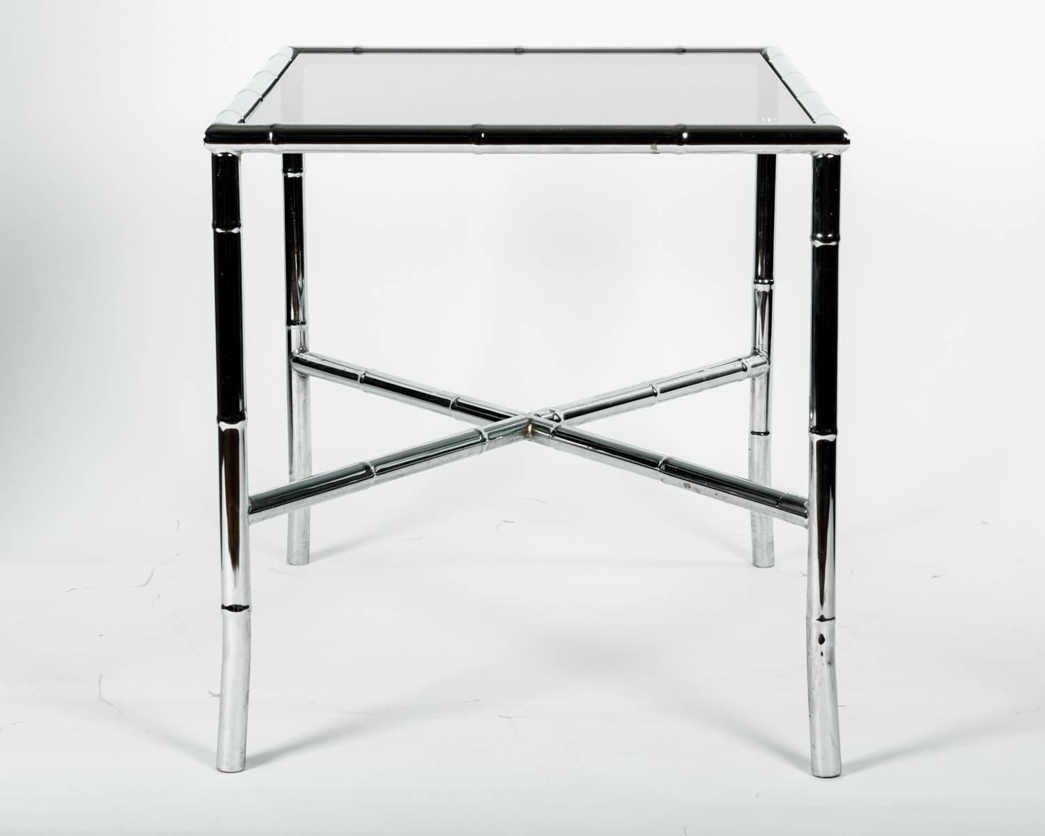 Mid-Century Modern tinted glass top coffee or cocktail table. Excellent condition. The cocktail table stand 26 inches long x 20 inches wide x 21 inches high.