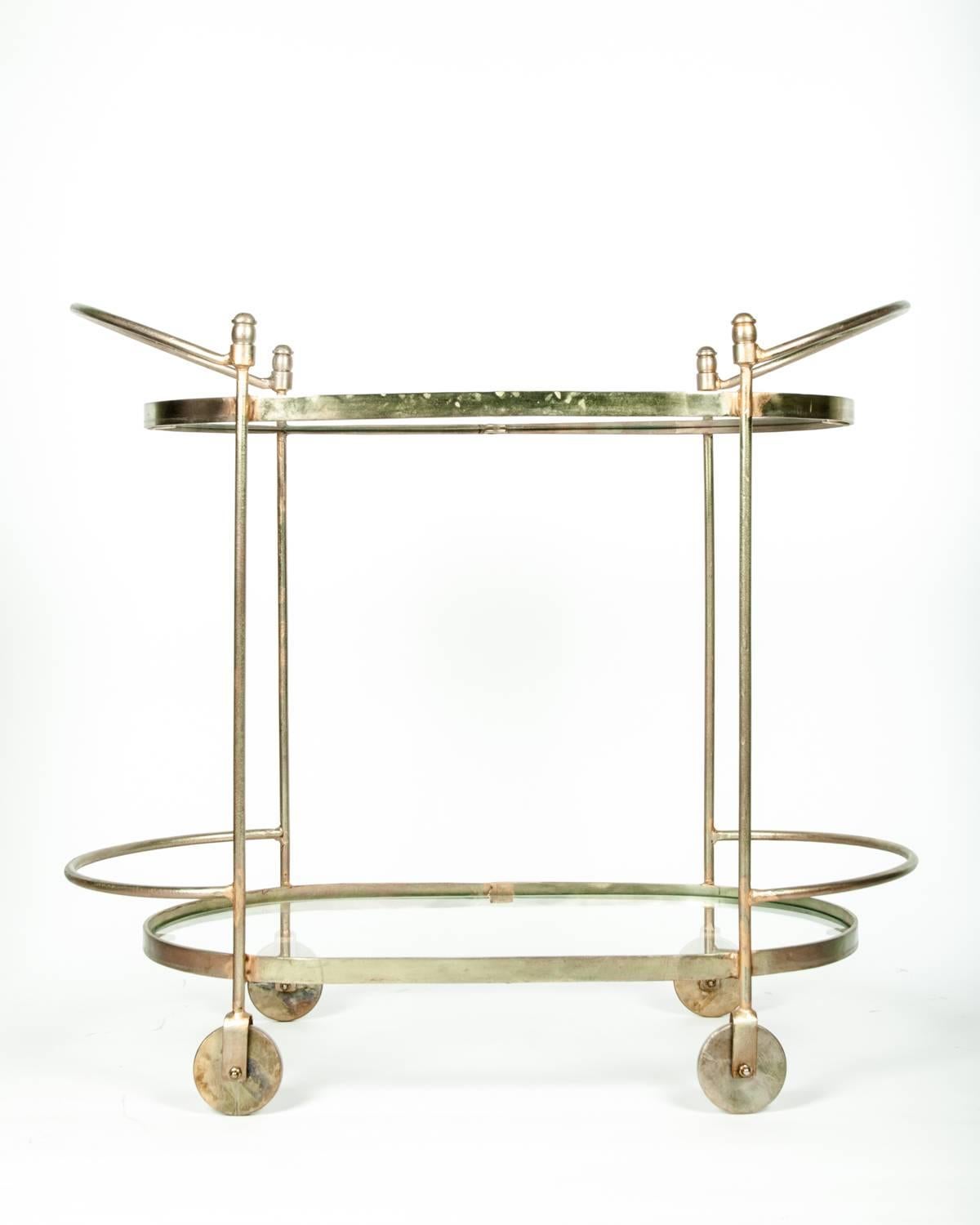 Mid-Century oval with two handles solid brass two-tier tea cart, serving table or bar cart. The tea cart Stand 34 inches long x 17 wide x 31 inches high.