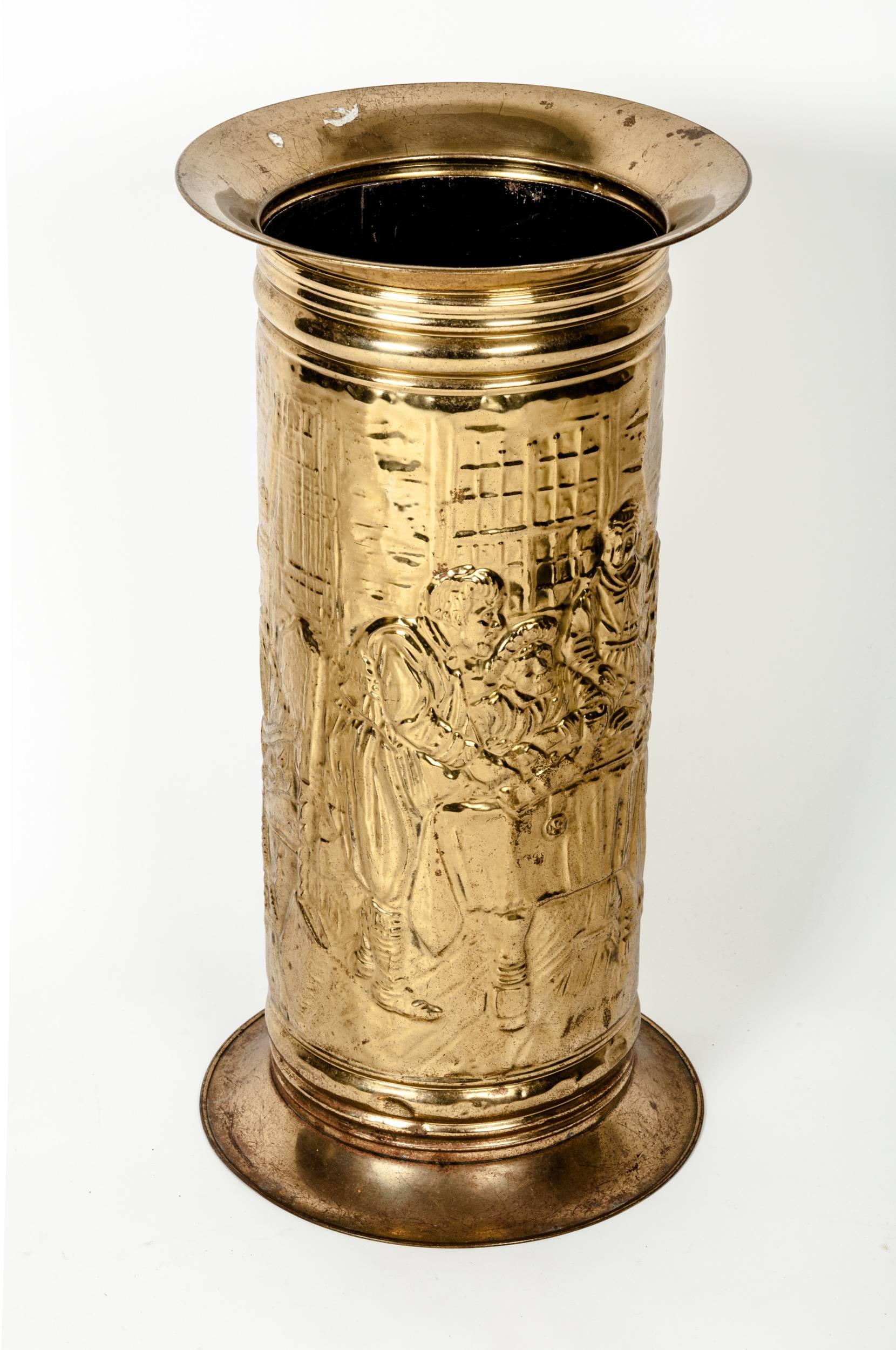 Vintage brass umbrella stand. This one is intricately embossed with a wonderfully detailed medieval scene.