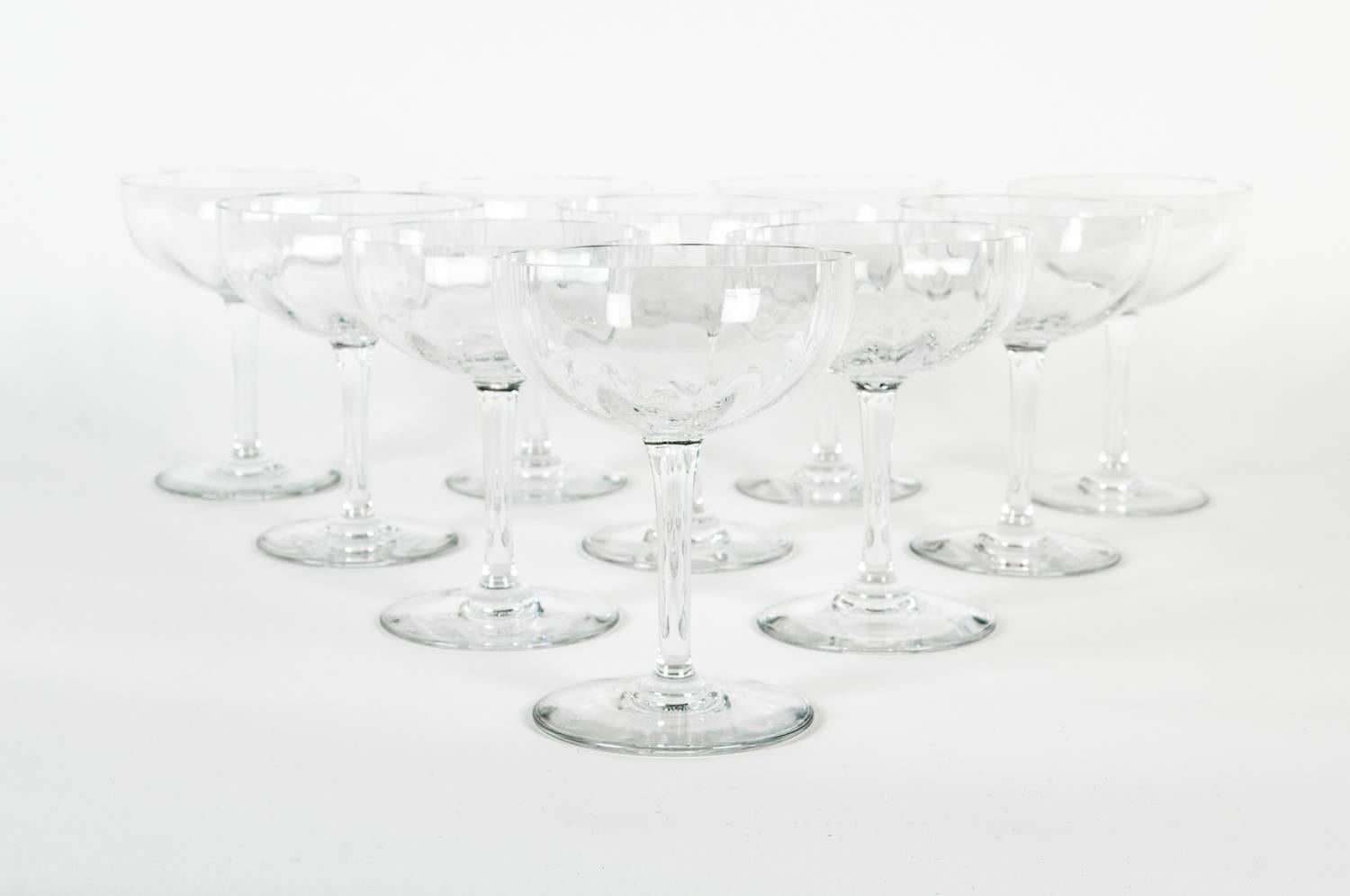 Set of ten vintage Baccarat acid-etched crystal champagne coupes. Maker's mark undersides. Excellent condition. Each coupe measure 5 inches high X 4 inches top diameter.