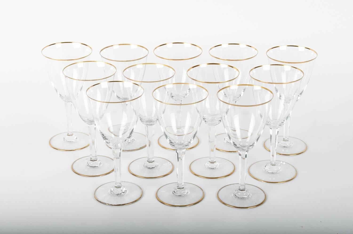 Vintage Baccarat crystal set of 12 wine or water glasses with gold trimmed top and base. Maker's mark on each glass. Excellent condition. Each glass measure 7 3/8 inches tall X 3 5/8 inches across X 3 1/4 inches base.