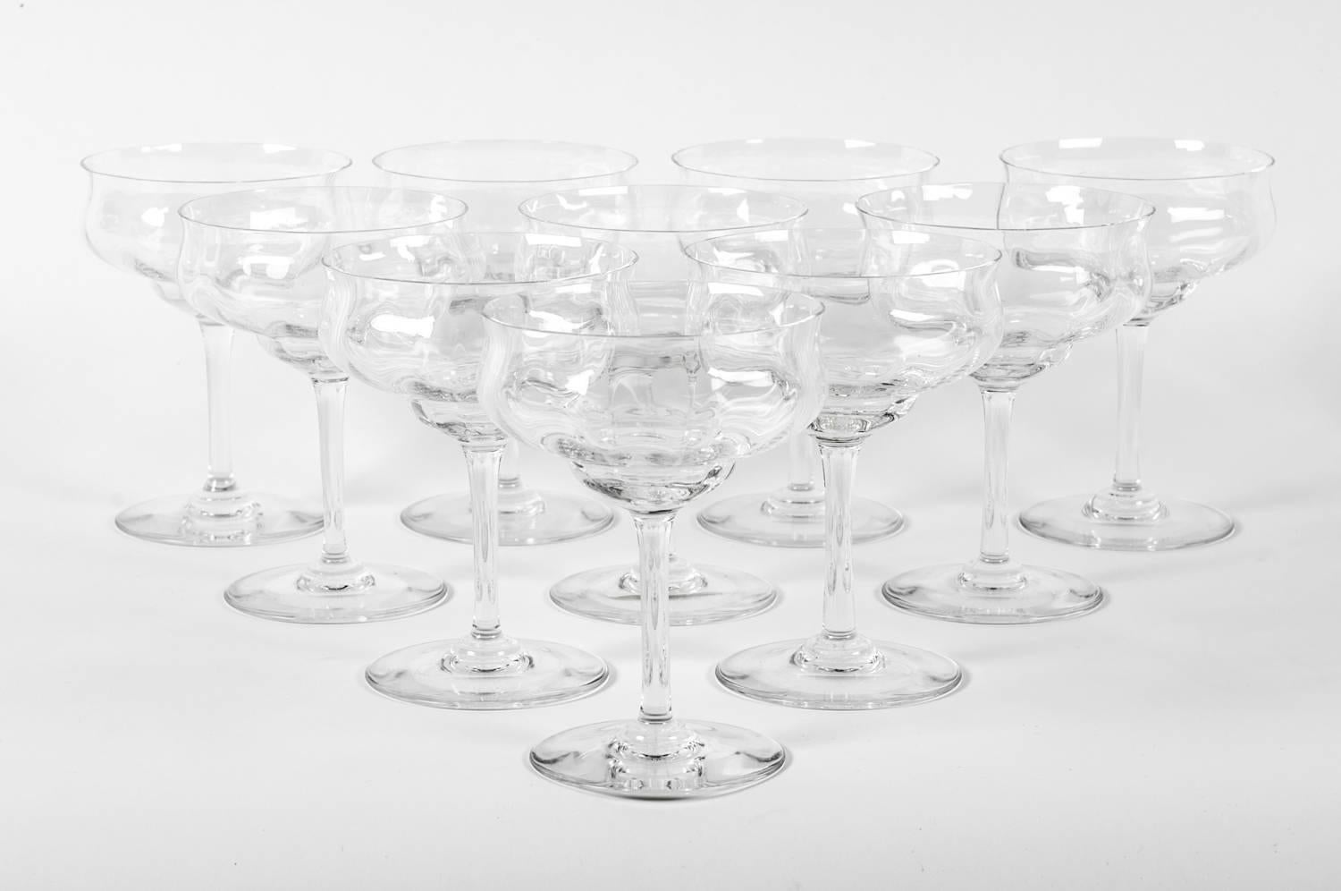 Vintage Baccarat crystal set of ten champagne or martini crystal coupes. Just exquisitely beautiful, these coupes would bring a great addition to any table or bar. Maker's mark acid etched on the base of each glass. We have three set of ten all in