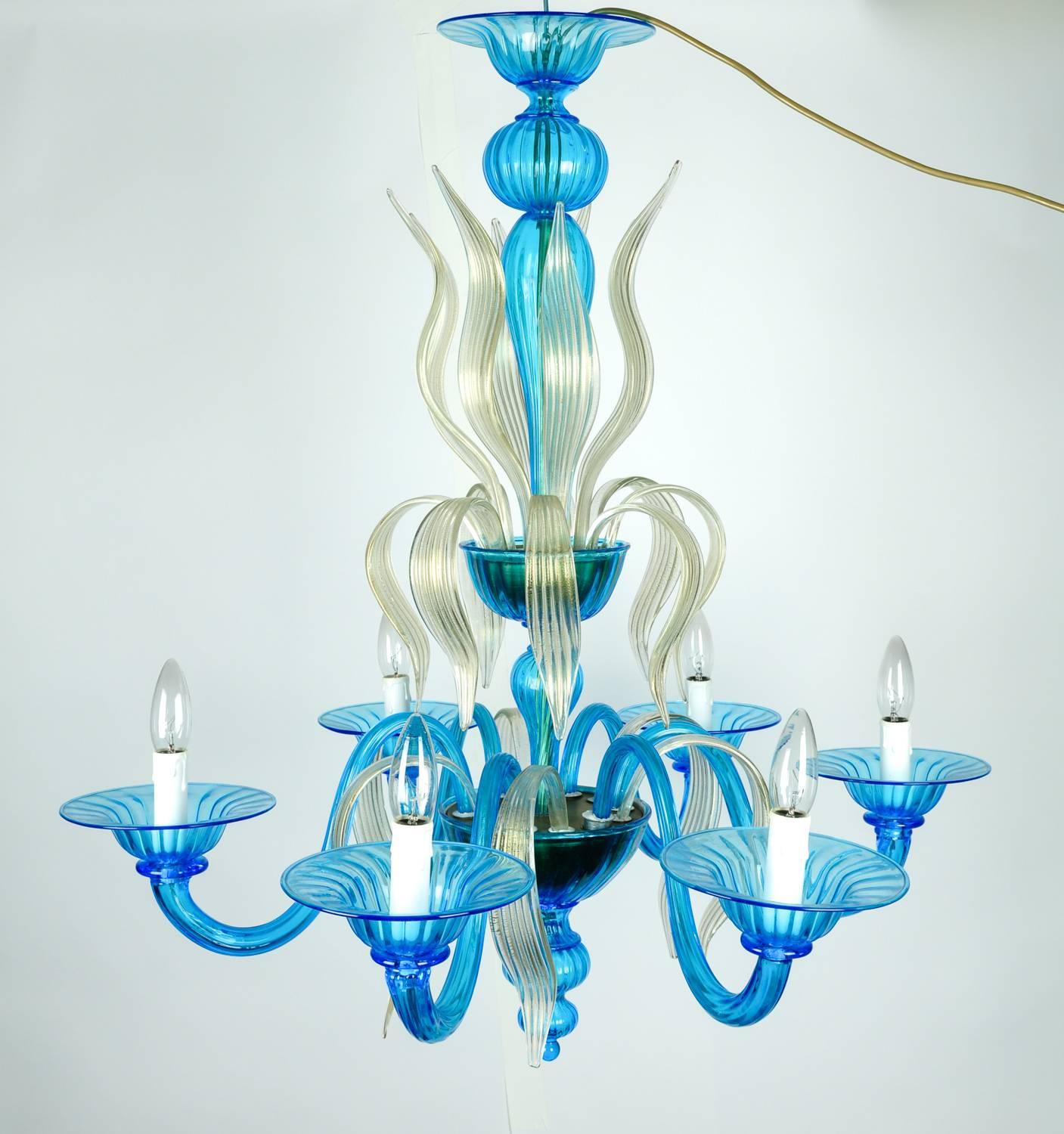 A stunning venetian handblown Murano glass chandelier in a turquoise and gold Flecks that add a touch of sparkle to the layered glass, with six branches. Rewired to US standards. The height without chain is 34 and the diameter is 30 inches .