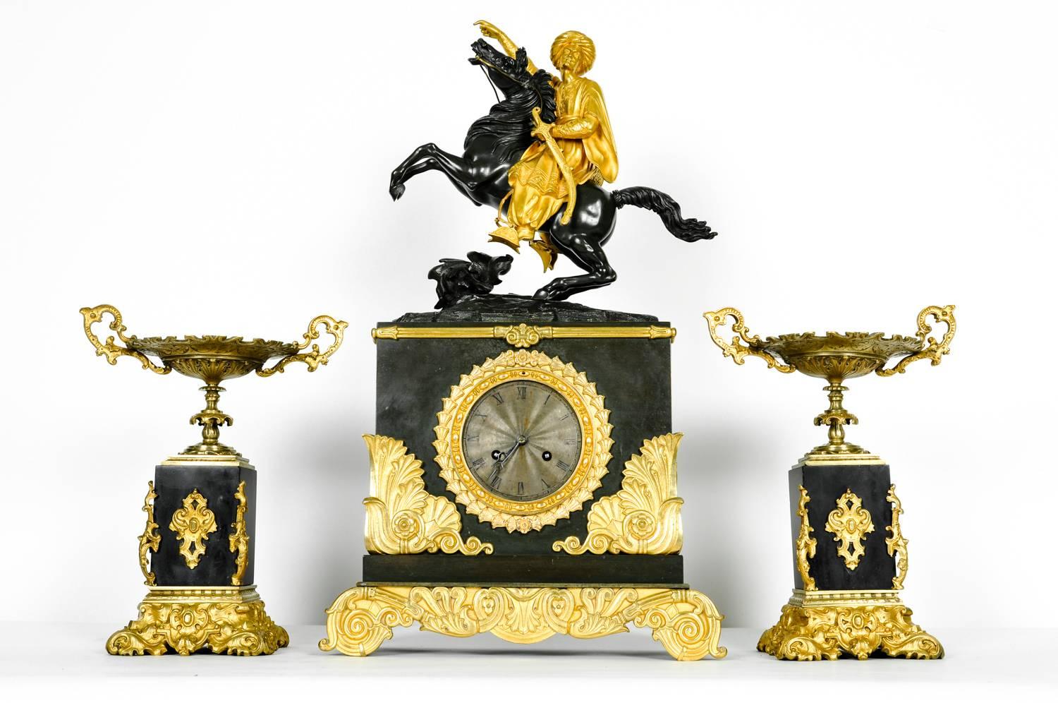 A fine and early 18th century French Empire ormolu fire gilded or bronze doré clock with two candleholder. The original gilding is in exquisite condition with a lovely golden glow. The clock depicts a soldier with his sword on top of his stallion.