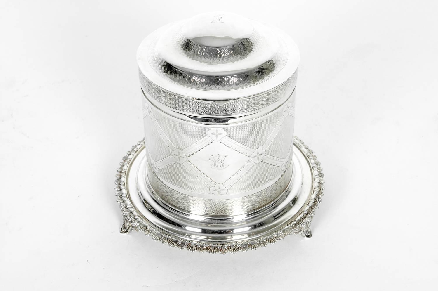 Old English silver plated biscuit box / tea caddy with footed ashberry holder. In excellent condition. The piece measure 8 inches high X 8 inches diameter.