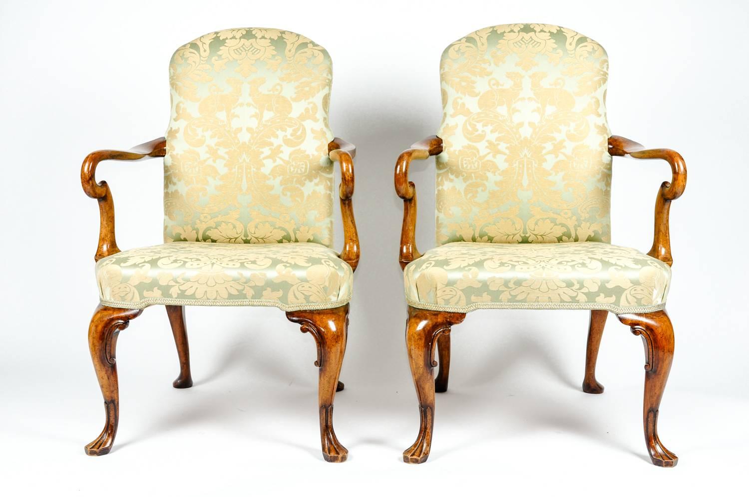 Antique pair of English side armchairs with green damask upholstery. Each armchair is in excellent condition, recently reupholstered. Each chair measure 38 inches high x 23 inches width x seat high 17 inches.