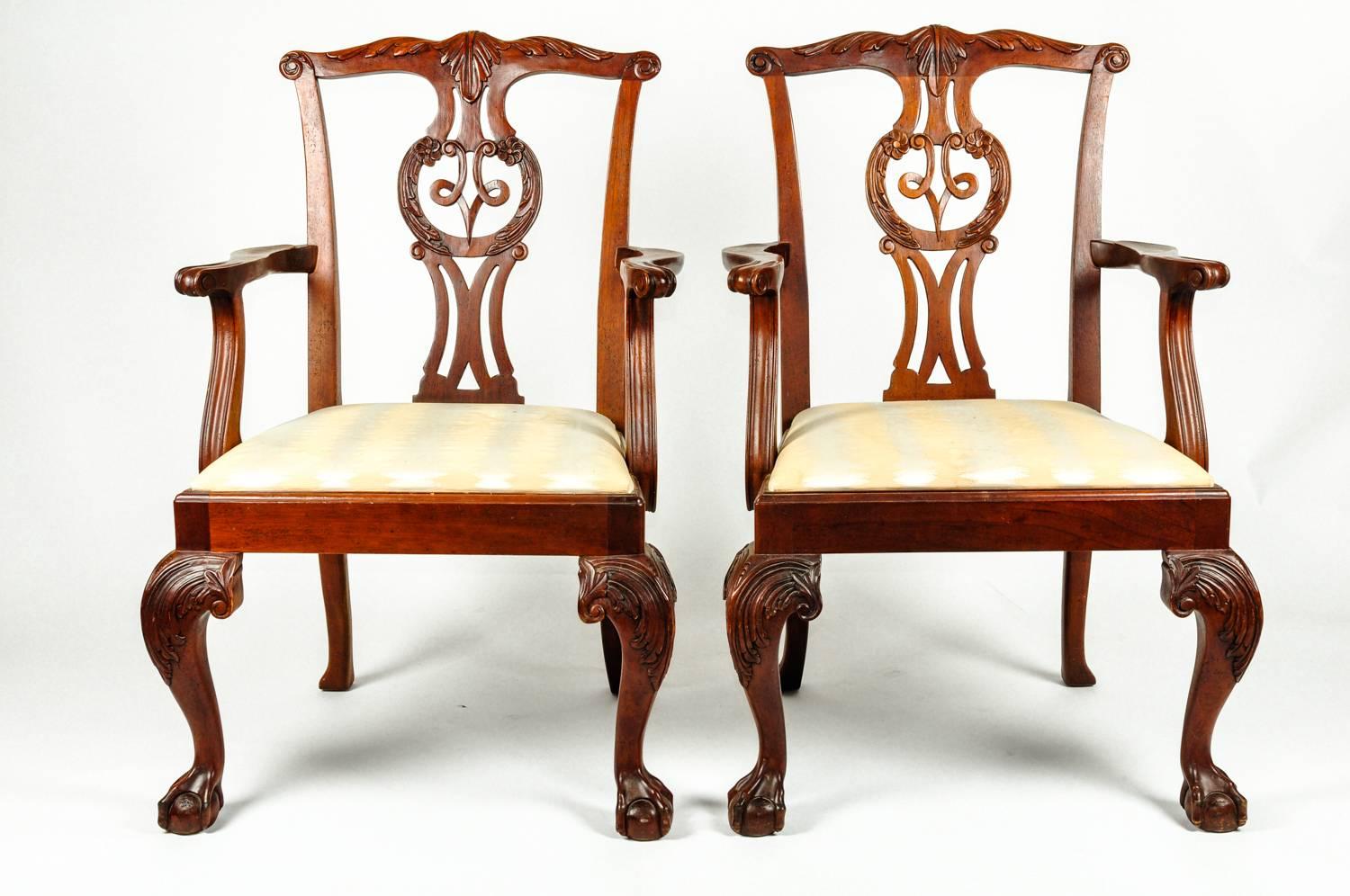 Vintage set of eight Georgian style solid mahogany dining room chairs by Baker. This fine set consists of two-arm and six side chairs each having a finely carved ball and claw foot leading to a cabriole leg. Each one is in excellent condition, new