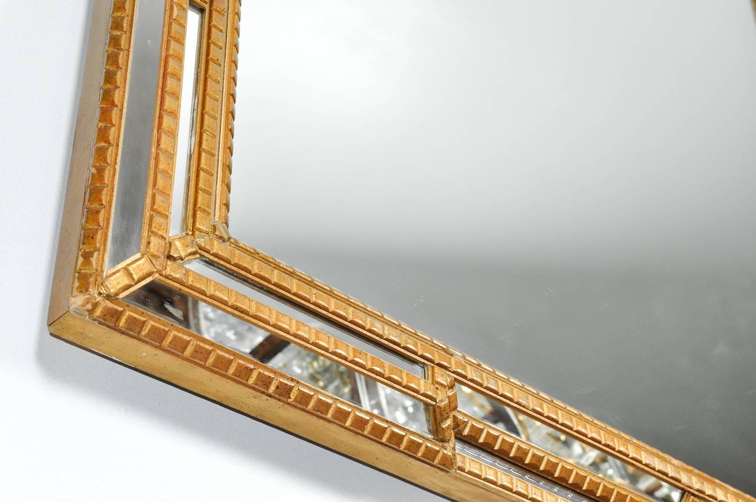 Giltwood frame beveled hanging wall mirror. Excellent condition. This piece would bring a great addition to any entrance, fireplace and study. The hanging wall mirror measure 58 inches length x 40 inches width x 3 inches deep.