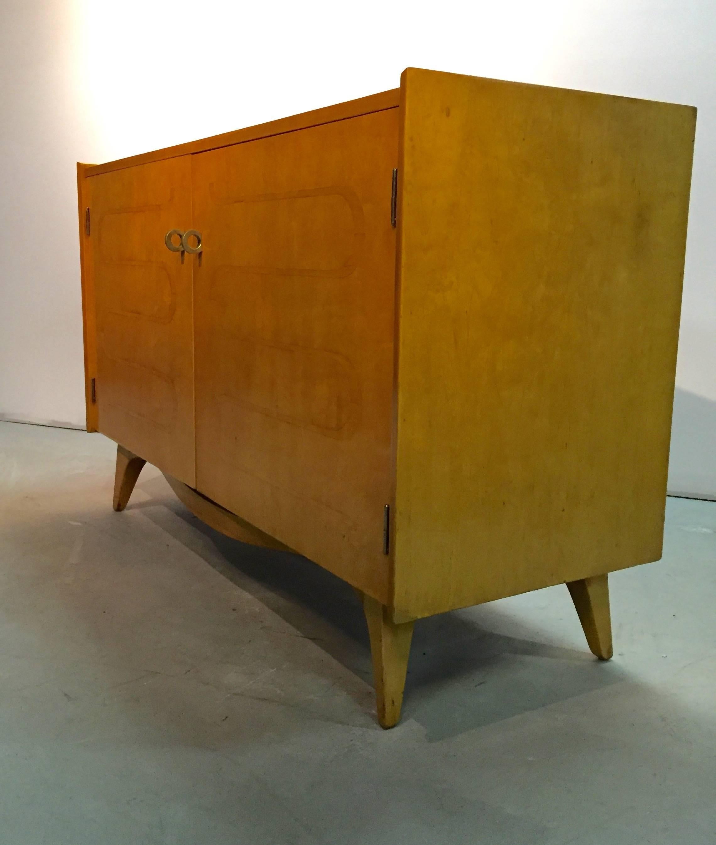 Swedish made cabinet from designer Edmond Spence. Featuring inlaid doors and hand-wrought brass hardware. A pair of adjustable height shelves and eight drawers are concealed by the doors. A beautiful and versatile cabinet. Recently restored to a