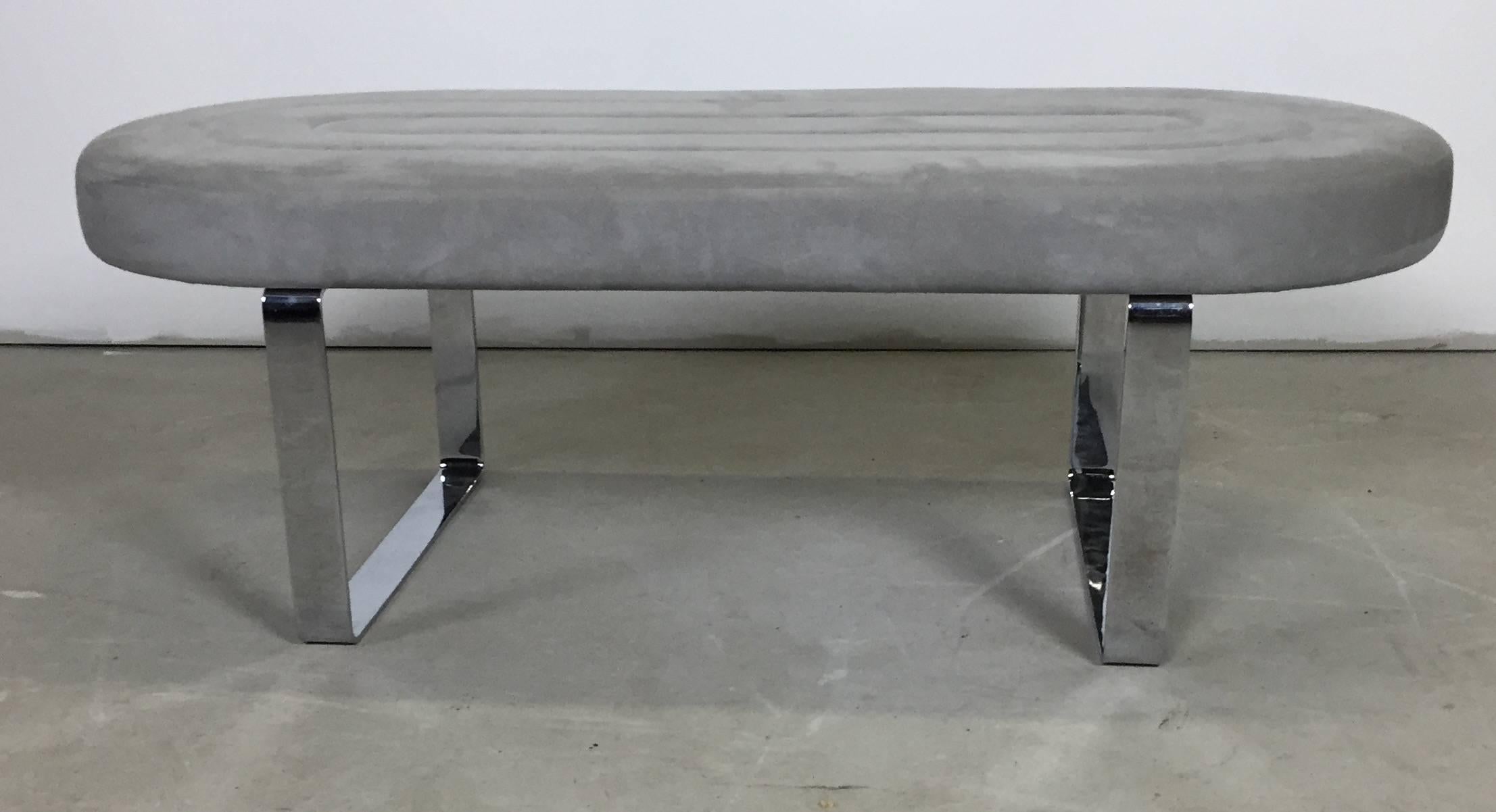 A bench upholstered in fine cropped gray velvet with concentric oval motif. Polished wide chrome band legs.
