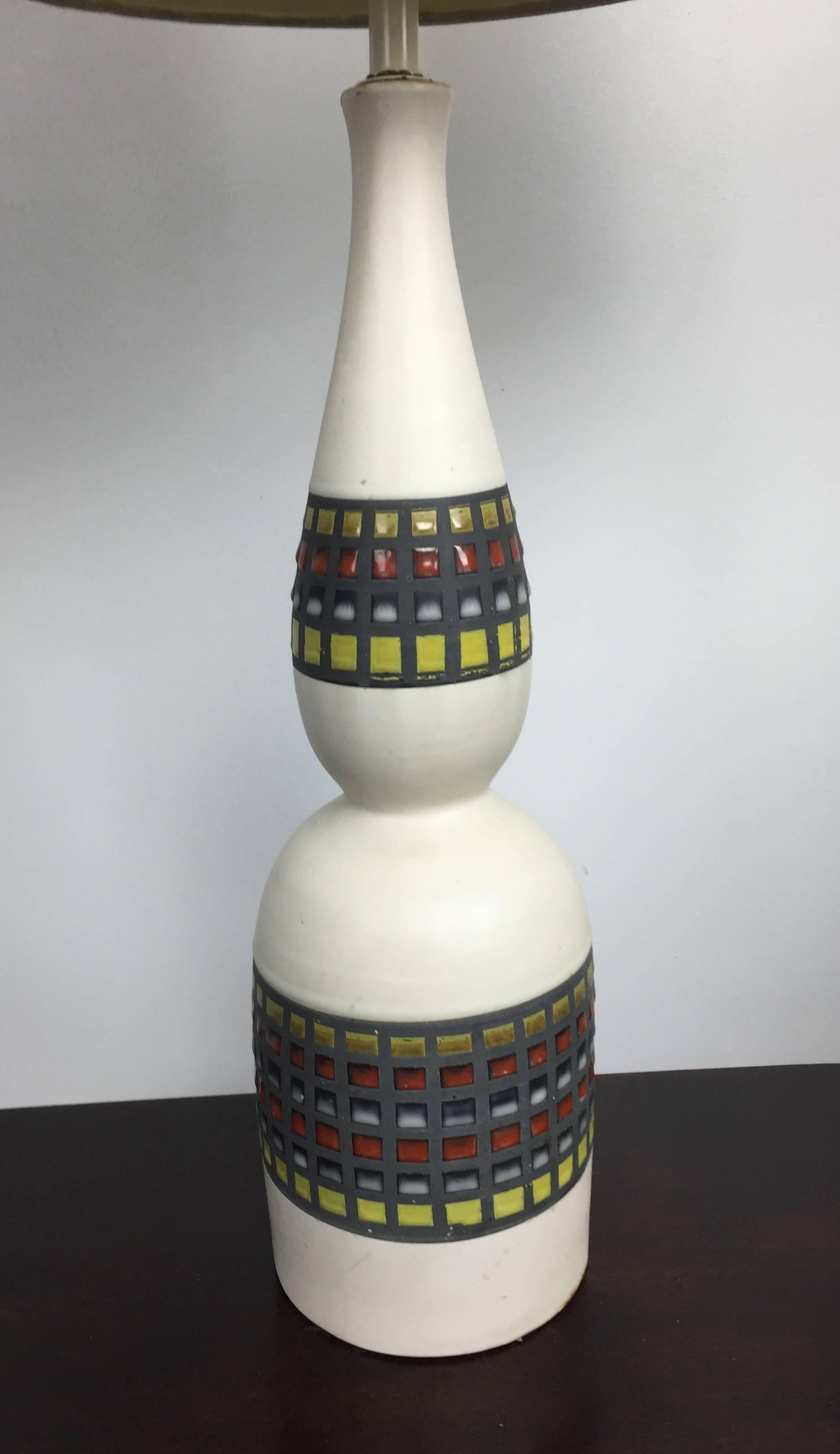 A beautiful pair of 1950s ceramic table lamps produced in Italy by The Bitossi firm. The glaze pattern evokes a Mosaic over a matte white pinched bottle base.