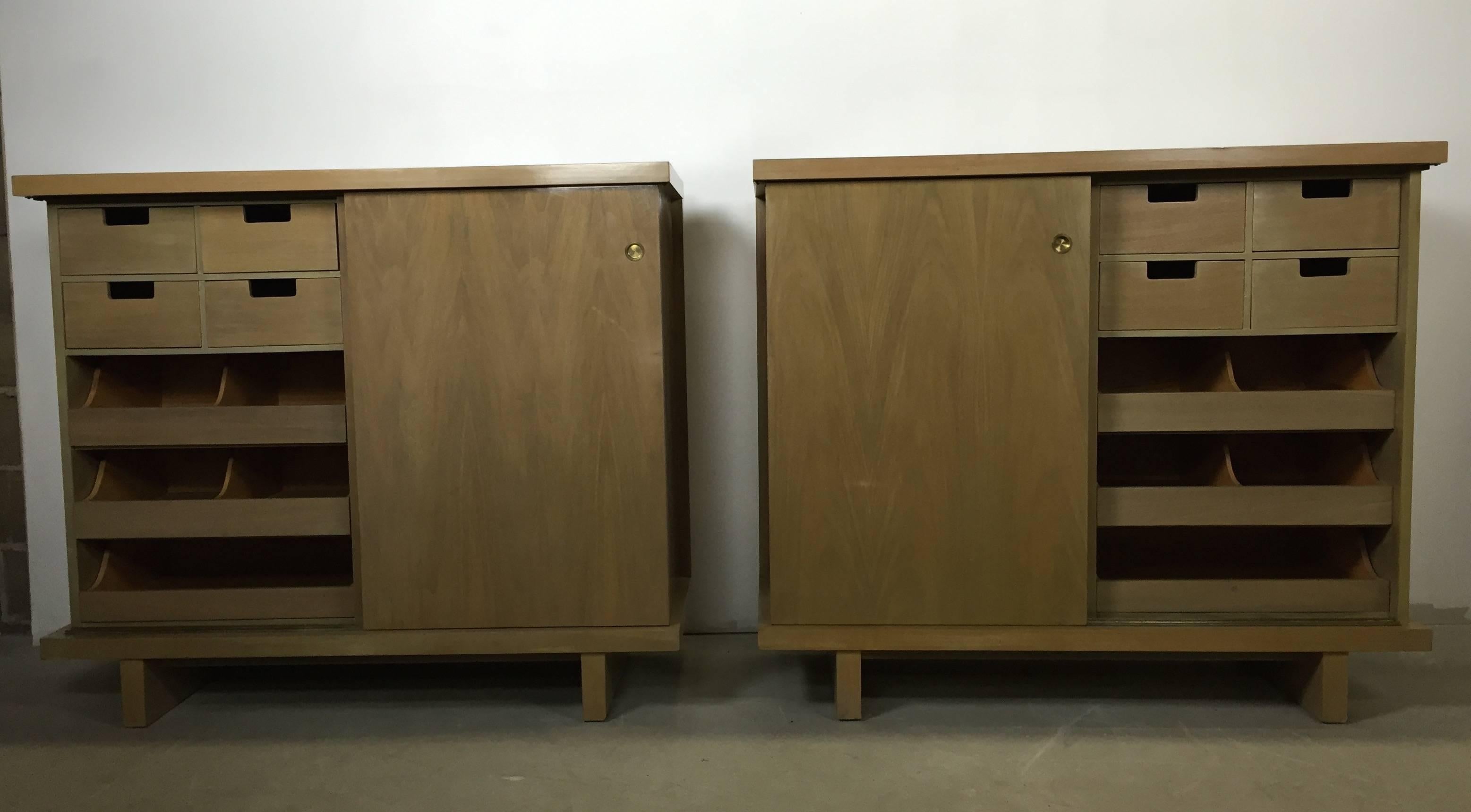 A pair of large matching chests with sliding doors and ten drawers finished in bleached walnut. Built & sold in the 1950s by American of Martinsville.