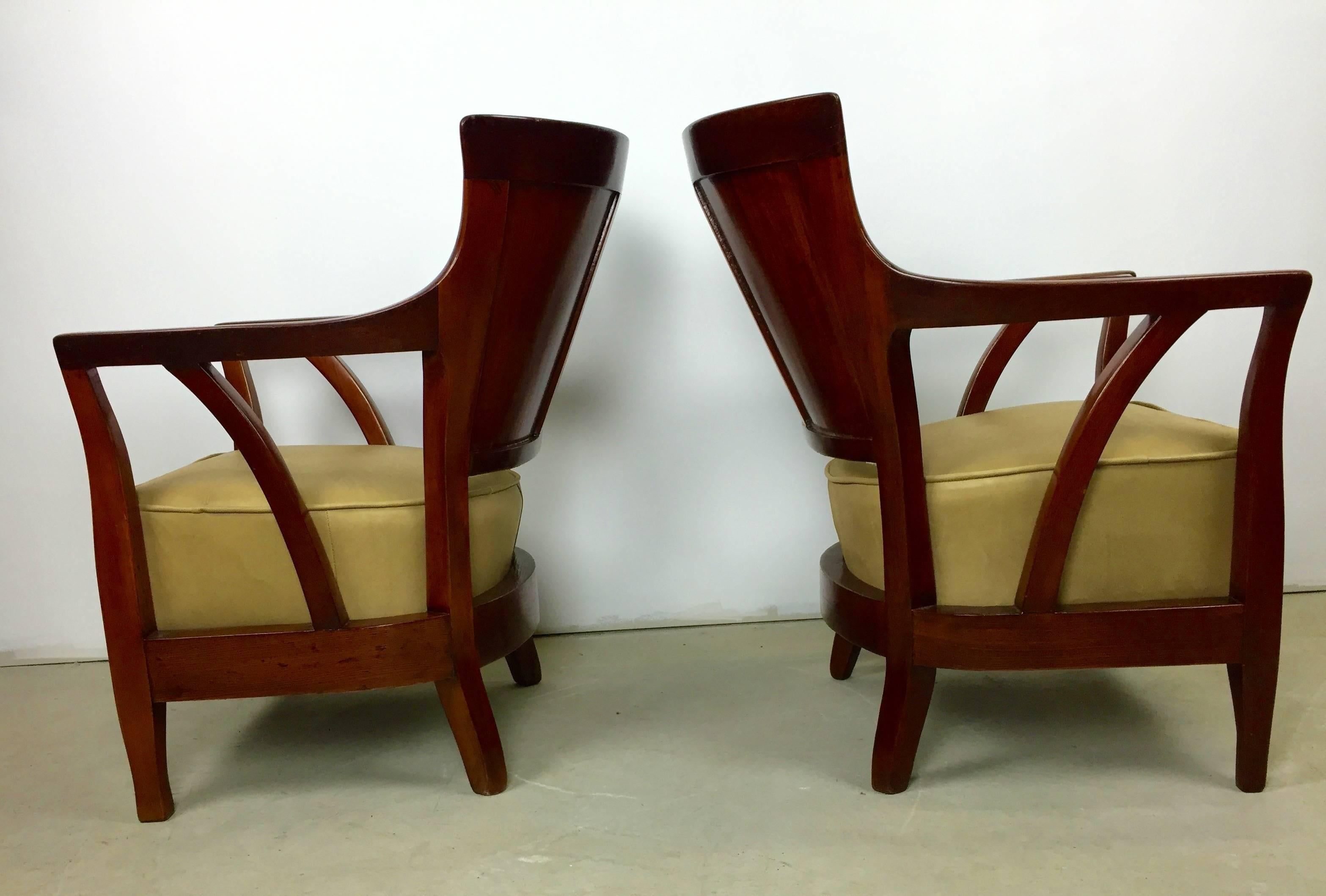 A rare pair of club chairs from the Viennese Secession. Walnut and pearwood frames freshly lacquered and reupholstered in beautiful buttercream leather. A stunning pair of chairs that we are glad to have brought back to life and proud to bring them