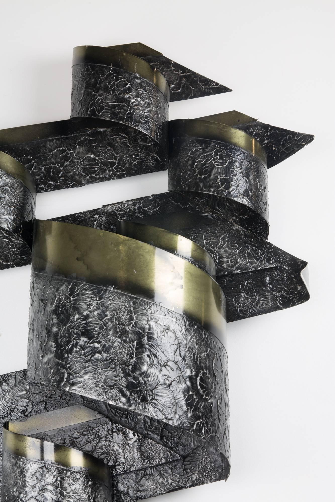 Brutalist steel and brass wall sculpture by C. Jeré for Artisan House with rough and smooth surface finishes. Retains original Artisan House tag, and is signed 