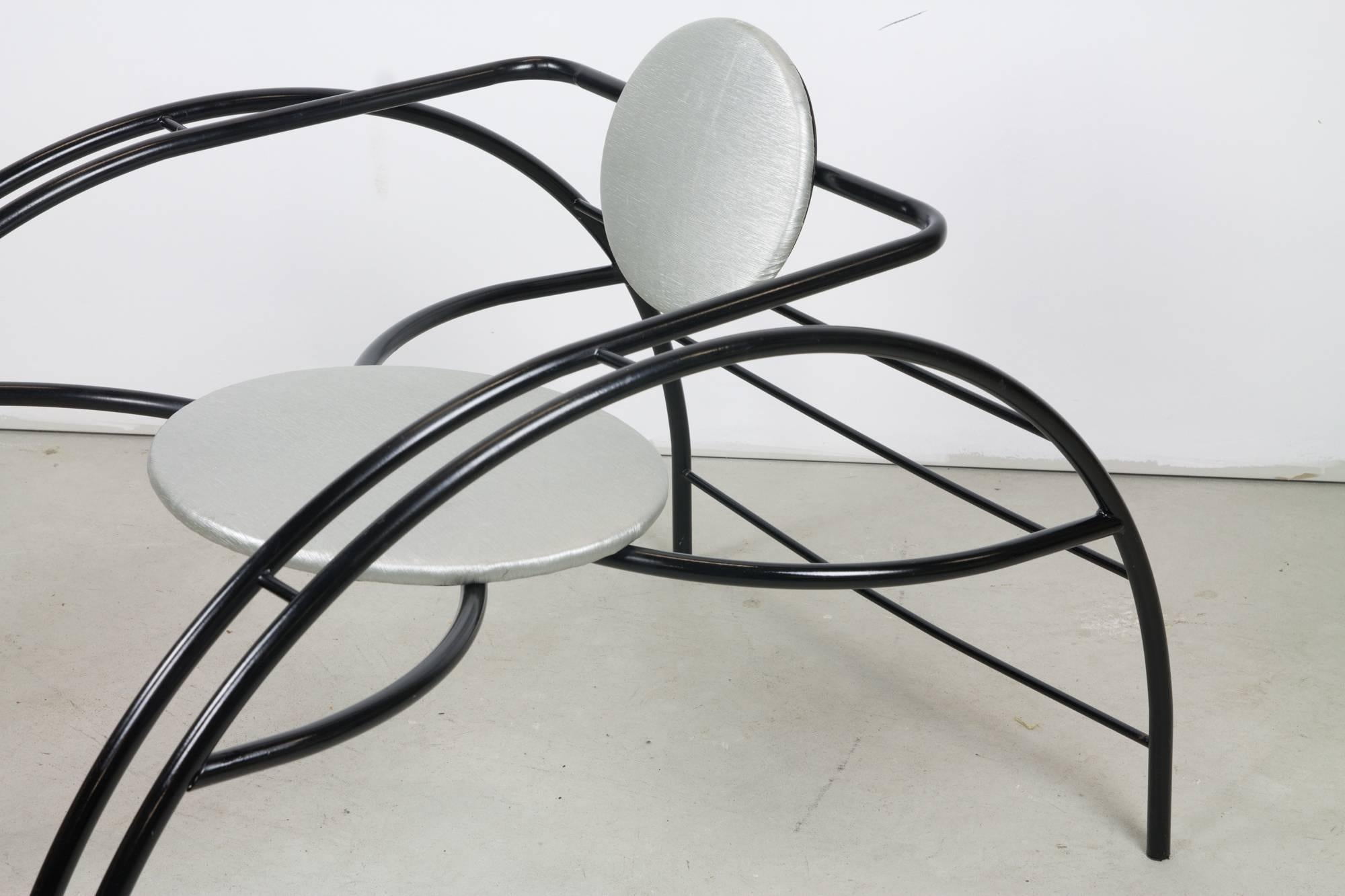 The Quebec 69 spider chair by Canadian postmodern Design Group Les Amisca featuring a bold exoskeleton of tubular steel, punctuated by a circular seat and backrest. Calling on tropes of Art Deco and the Machine Age, this chair serves as both a