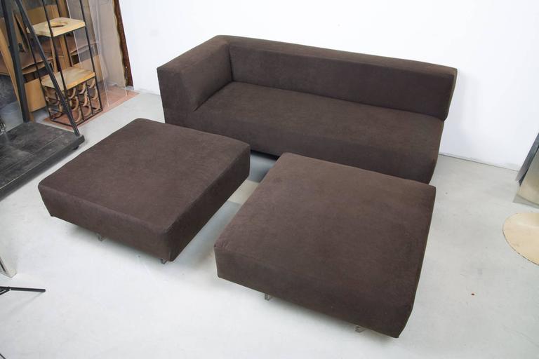 Omnibus sofa with two square ottomans by Vladimir Kagan. The rectilinear sofa features one thick Lucite leg, lightening the otherwise robust modular form. The two square ottomans, each with two Lucite legs, work in a variety of arrangements around