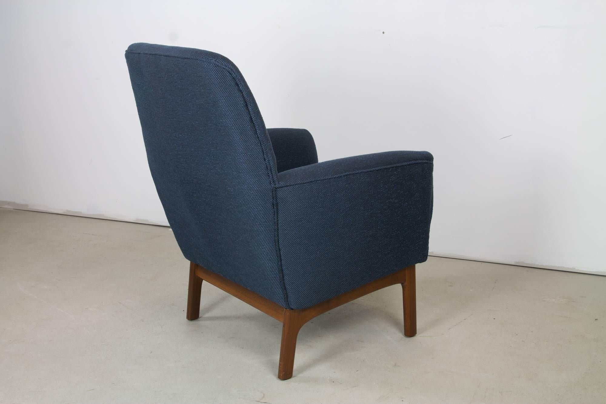 A compact and very comfortable easy chair by DUX with teak rails and legs, newly upholstered in navy Knoll fabric.
 
