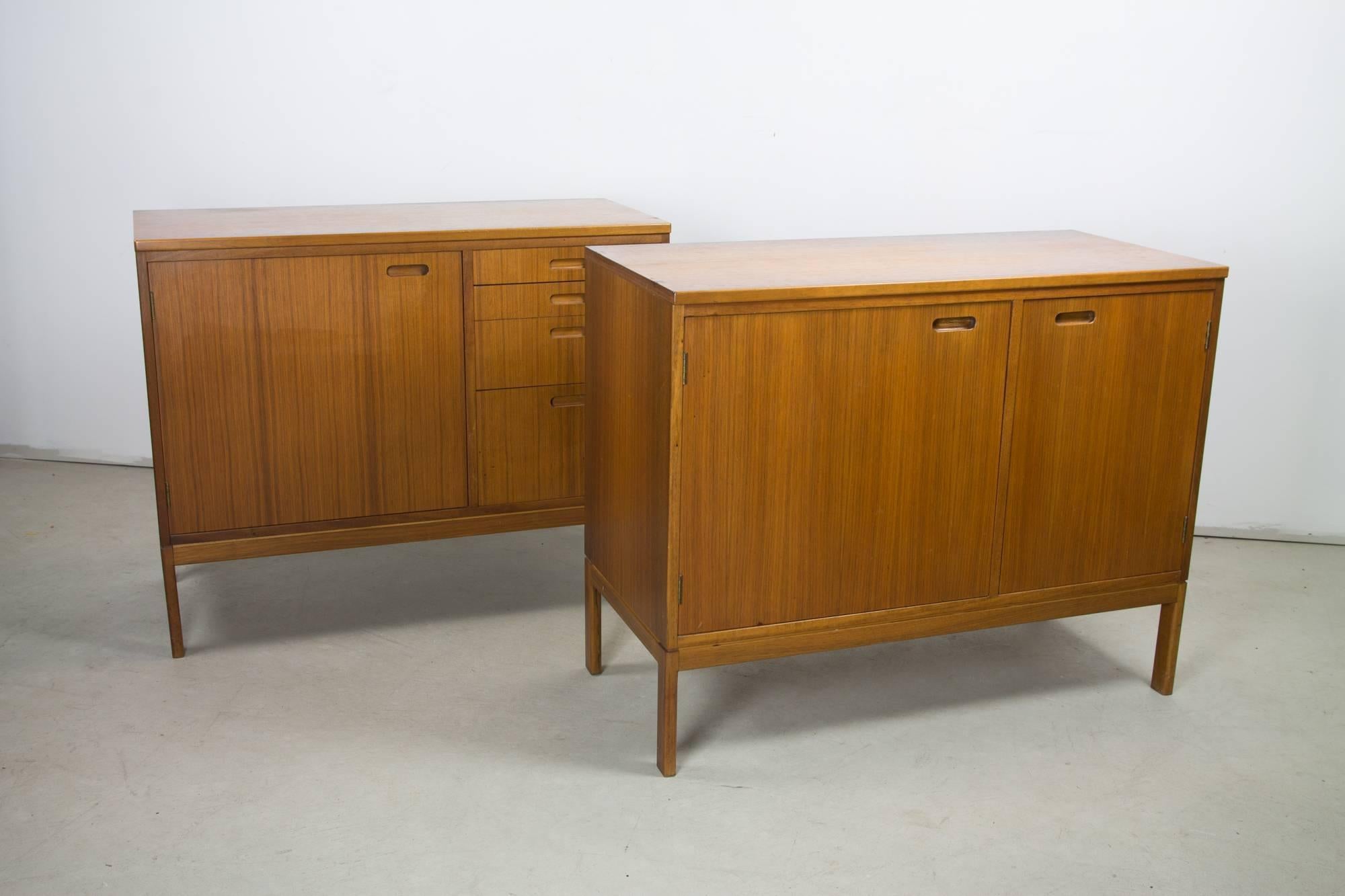 Two cabinets attributed to Directional, with inner shelving and various sized drawers, and a desk piece with two drawers, which suspends between the cabinets via small brass brackets. The desk piece can be easily detached for alternate arrangement