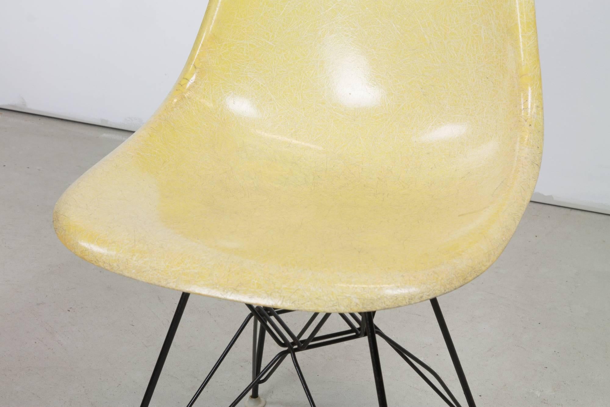 Herman Miller Eames DSR fiberglass chair on Eiffel base in bright yellow. Base has excellent patina and original glides and shock mounts.