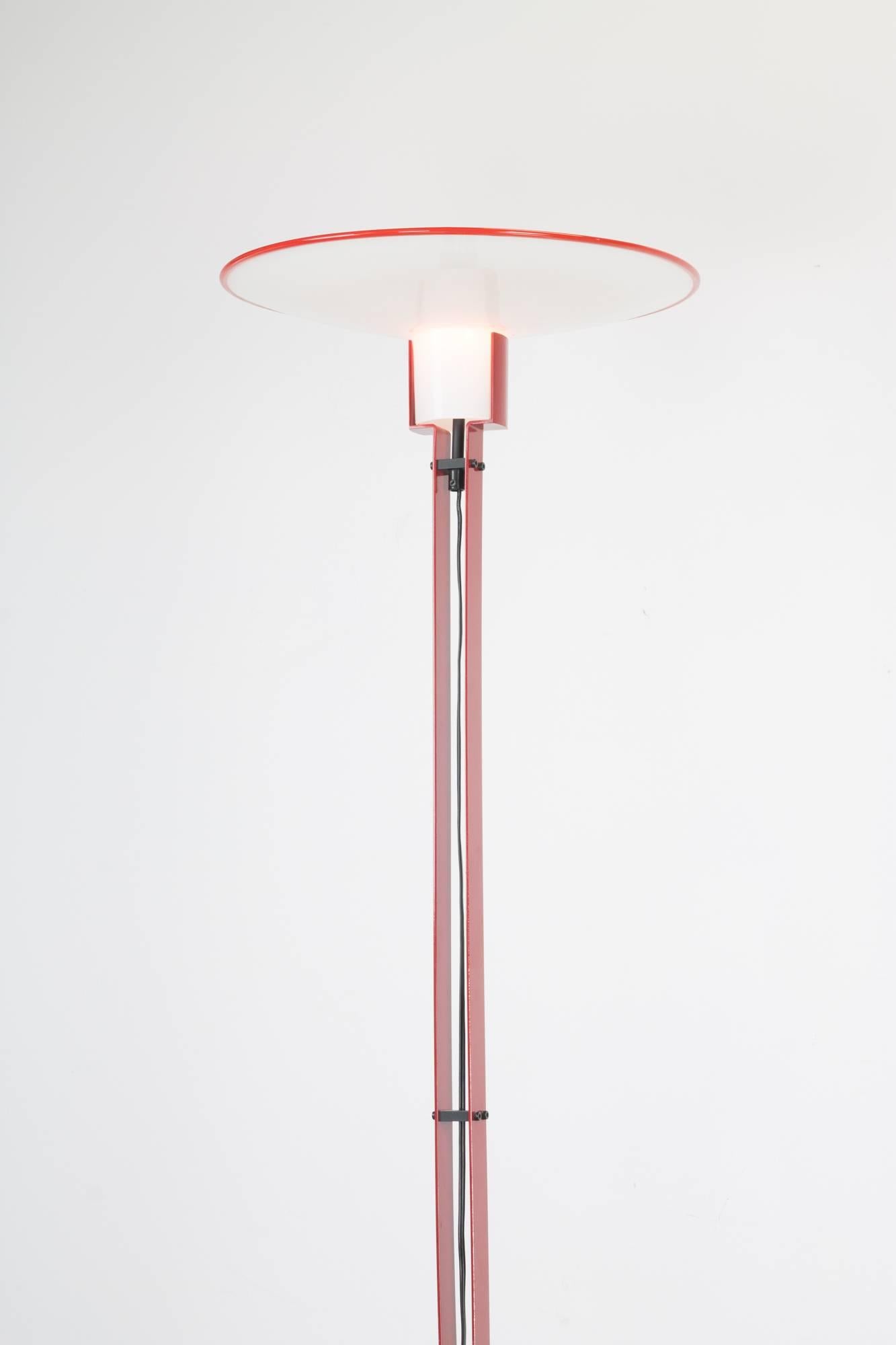 An exemplary 1970s Italian floor lamp by Relux, with circular enameled black steel base and two red flat steel bars running parallel upward with the cord, terminating at the milk white Murano glass shade with red trim. (Shade diameter is 15 in.)