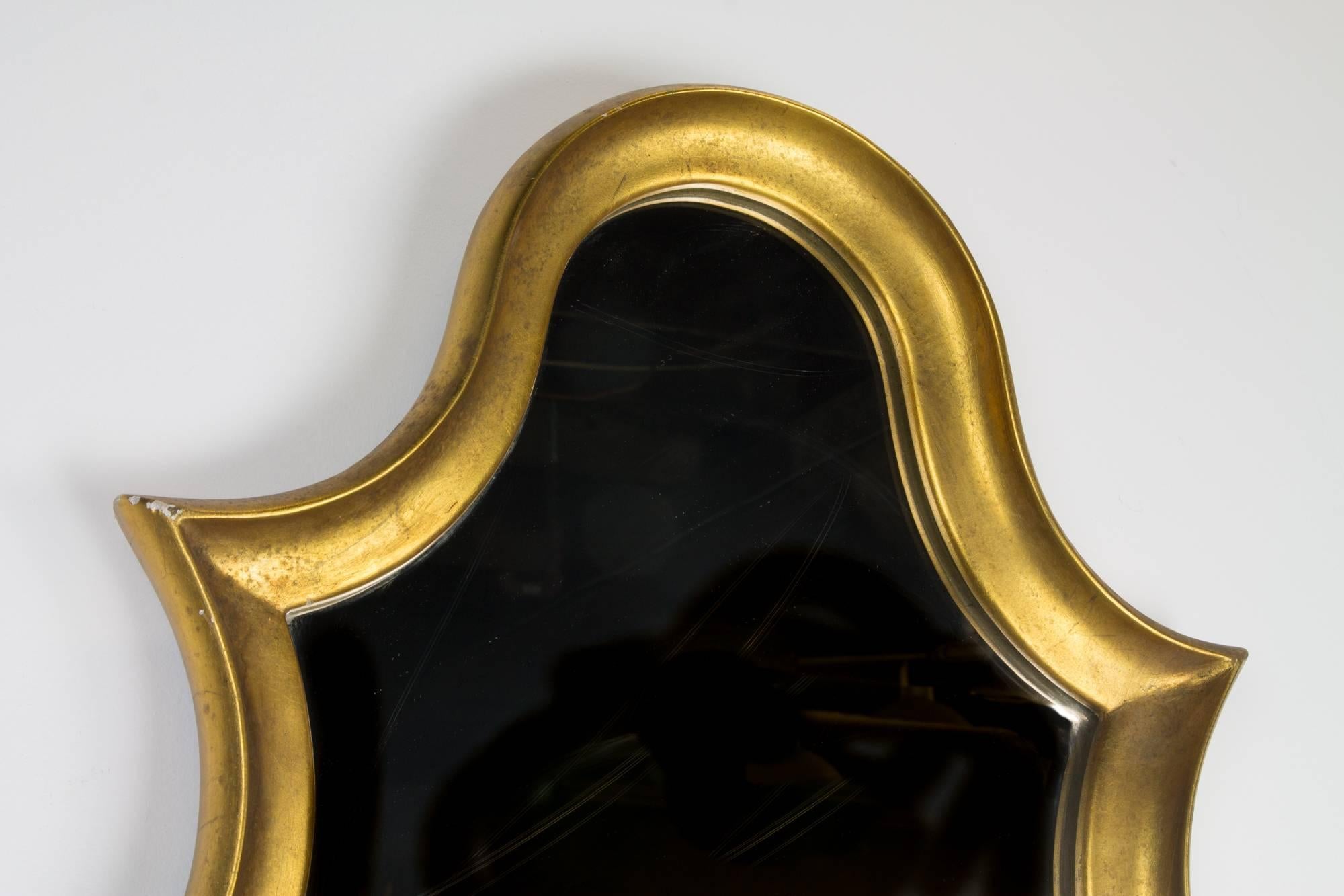 Elegant cartouche form gilded wood framed wall mirror in the manner of La Barge.