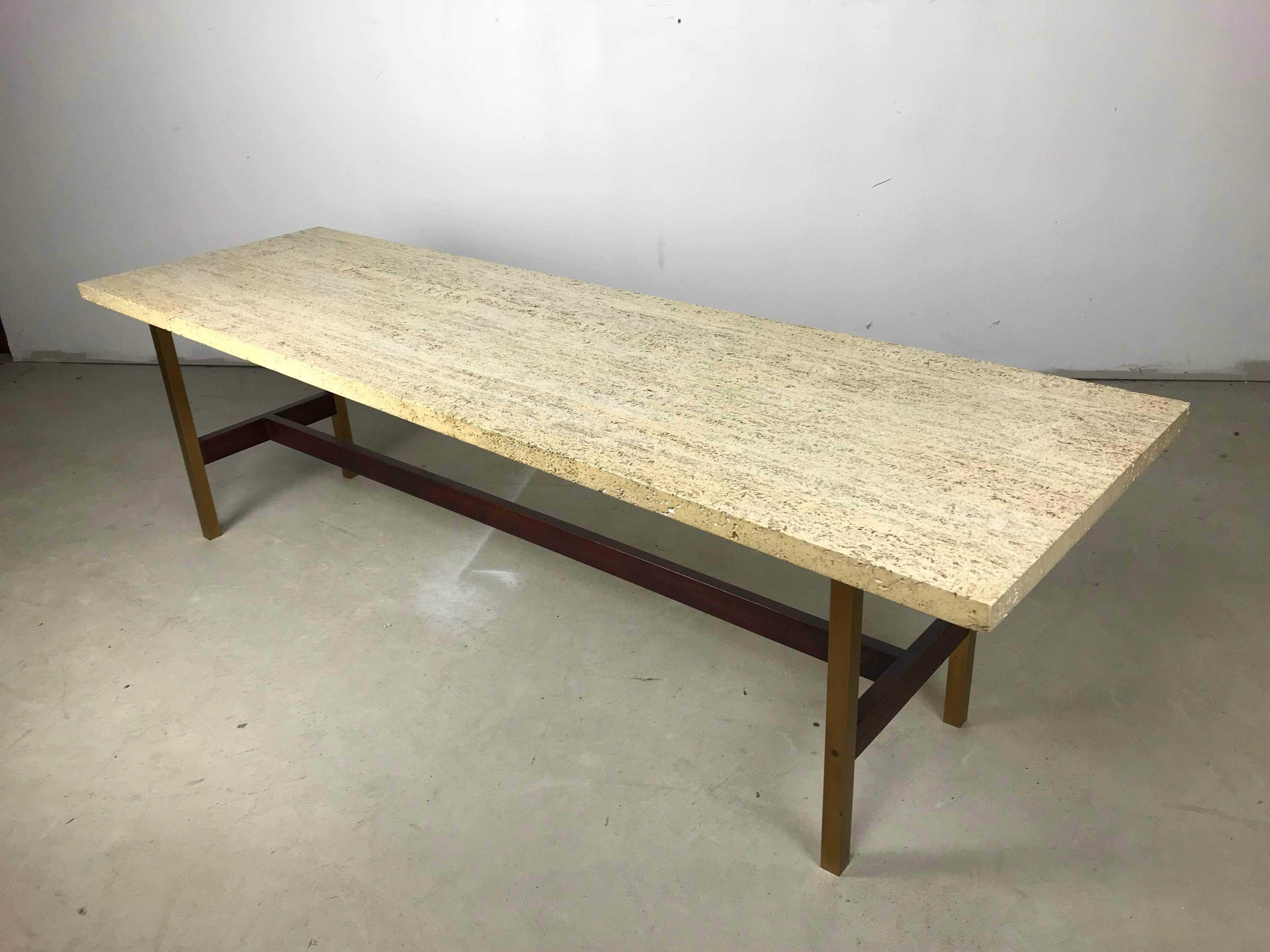 Here is a rare one of a kind custom design by the Late NYC designer Phillip Enfield. Its a beautifully made cocktail table constructed of solid walnut and brass, featuring a Travertine marble top. The quality of the construction and simple beauty of