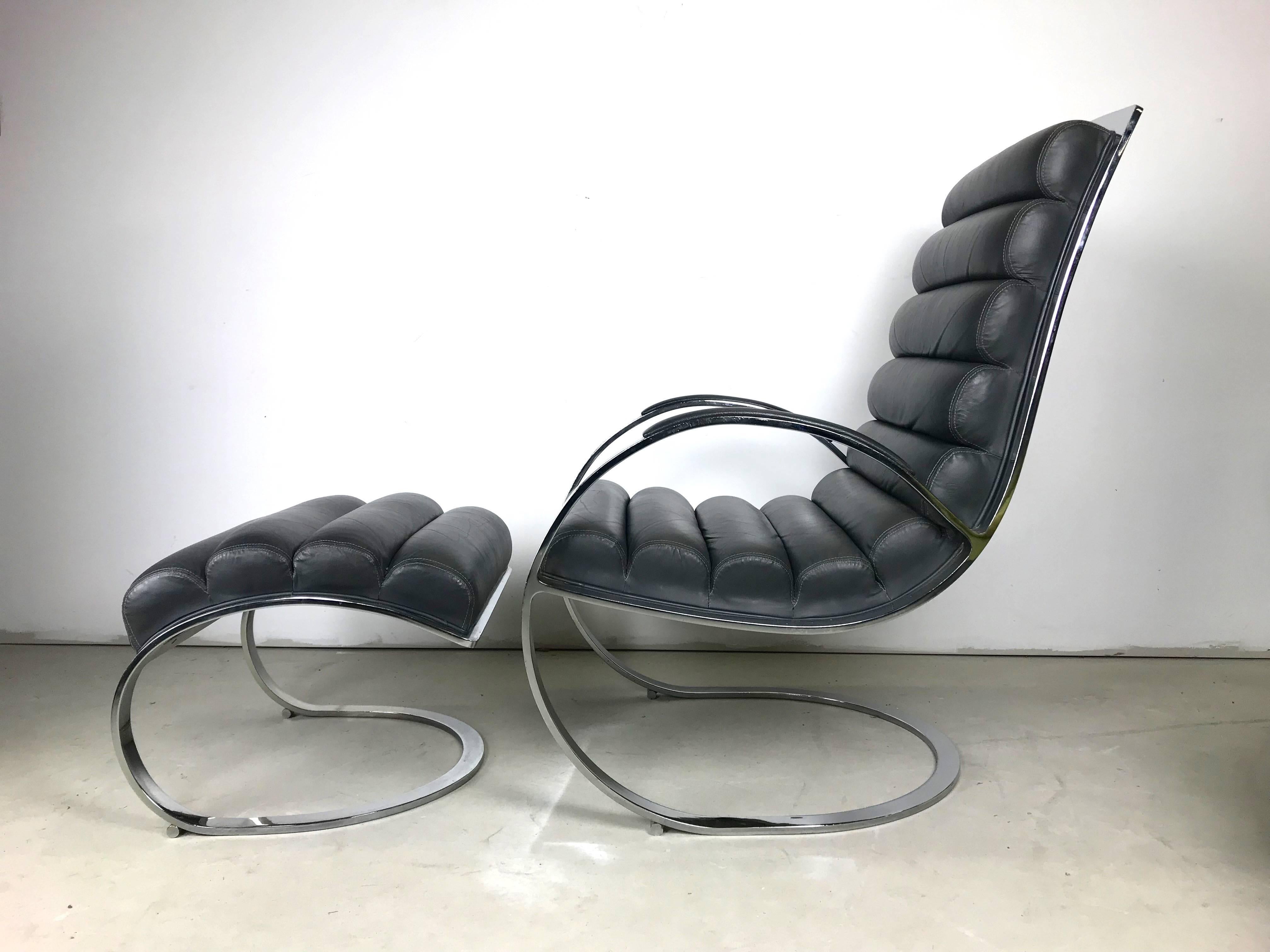 This is a fine tufted leather and heavy chromed steel lounge chair and ottoman designed by Milo Baughman in the 1970s the leather is charcoal grey and is in very nice condition, supple with just the right amount of give. The chromed frame is very