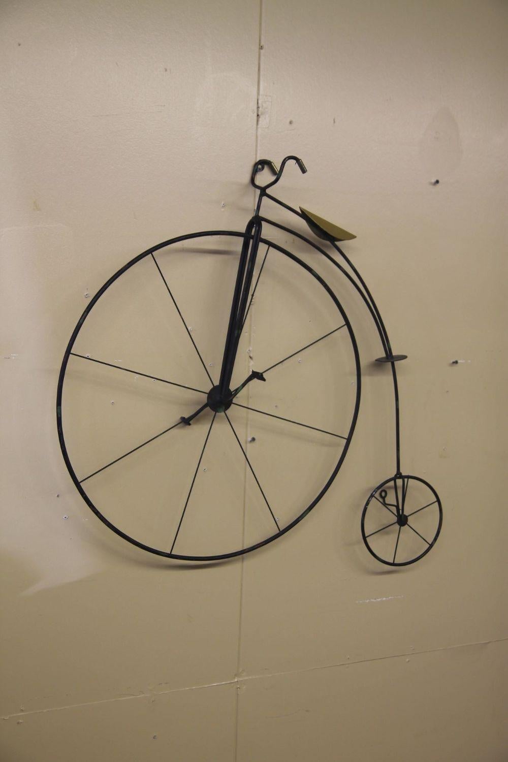 Pleased to offer this wall hanging high wheel metal bike sculpture by Curtis Jere. This piece is marked 1992. The black bike has a nice brass seat.
