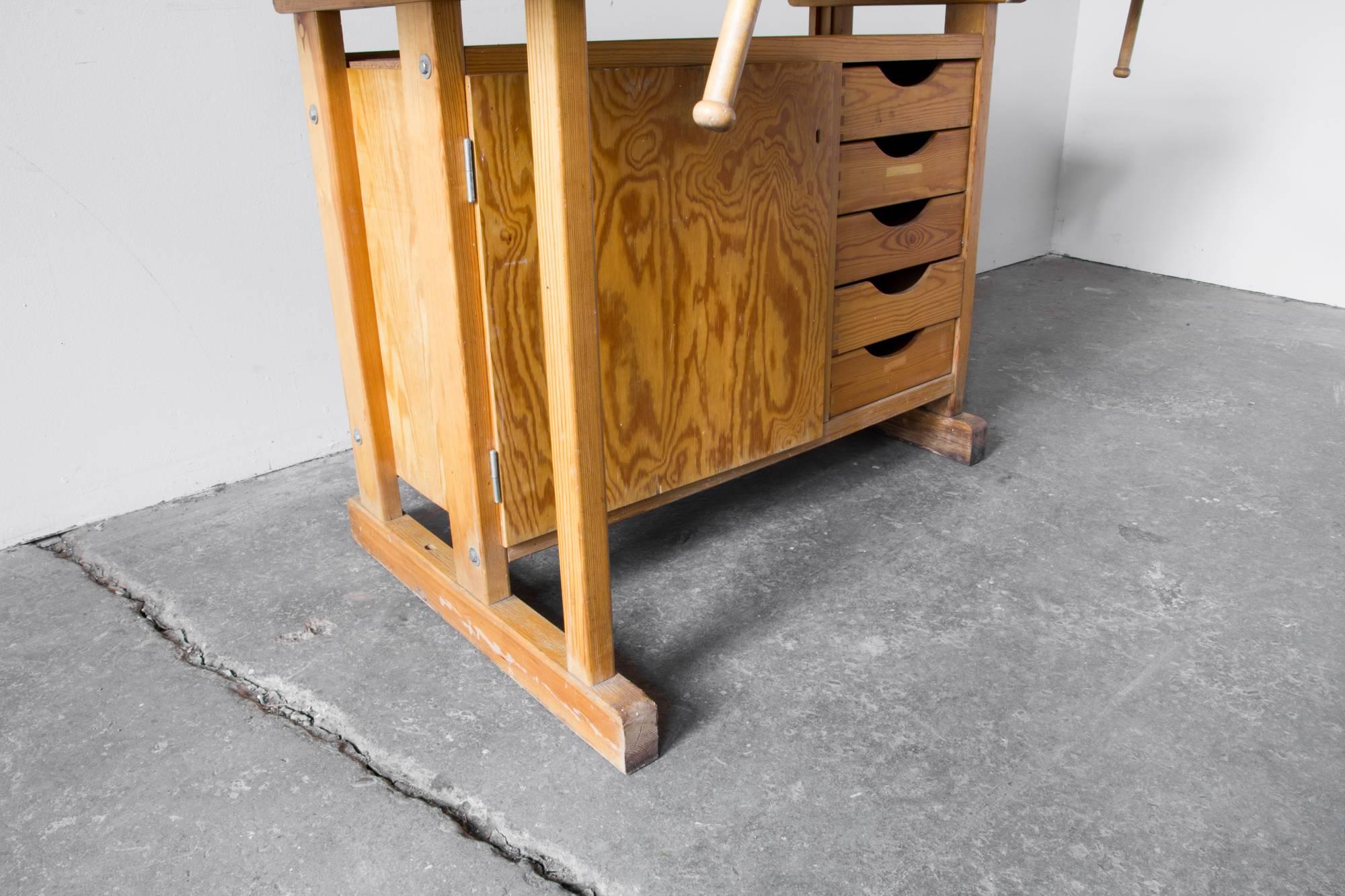 Swedish made woodworking bench by Sjobergs, the choice brand of woodworkers since the company's inception in the 30s. Smartly and sturily constructed in pine, with five dovetailed drawers and a cabinet with figural douglas fir plywood door.
