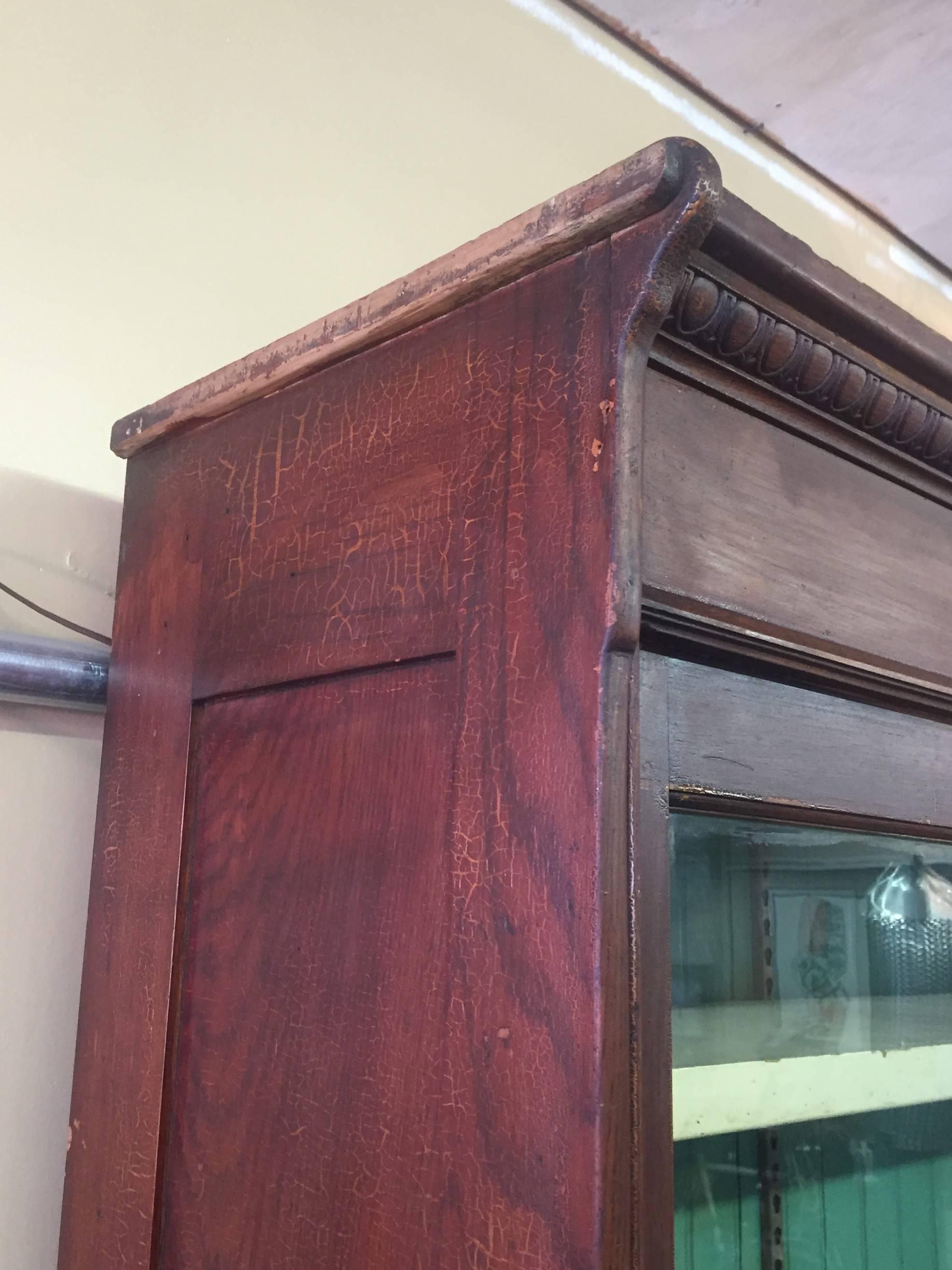 High quality turn of the century country store seed cabinet in oak, manufactured in Chicago by J.D. Warren, with lower shelving via sliding doors, 20 small seed drawers, and three upper shelves via original glass sliding doors.