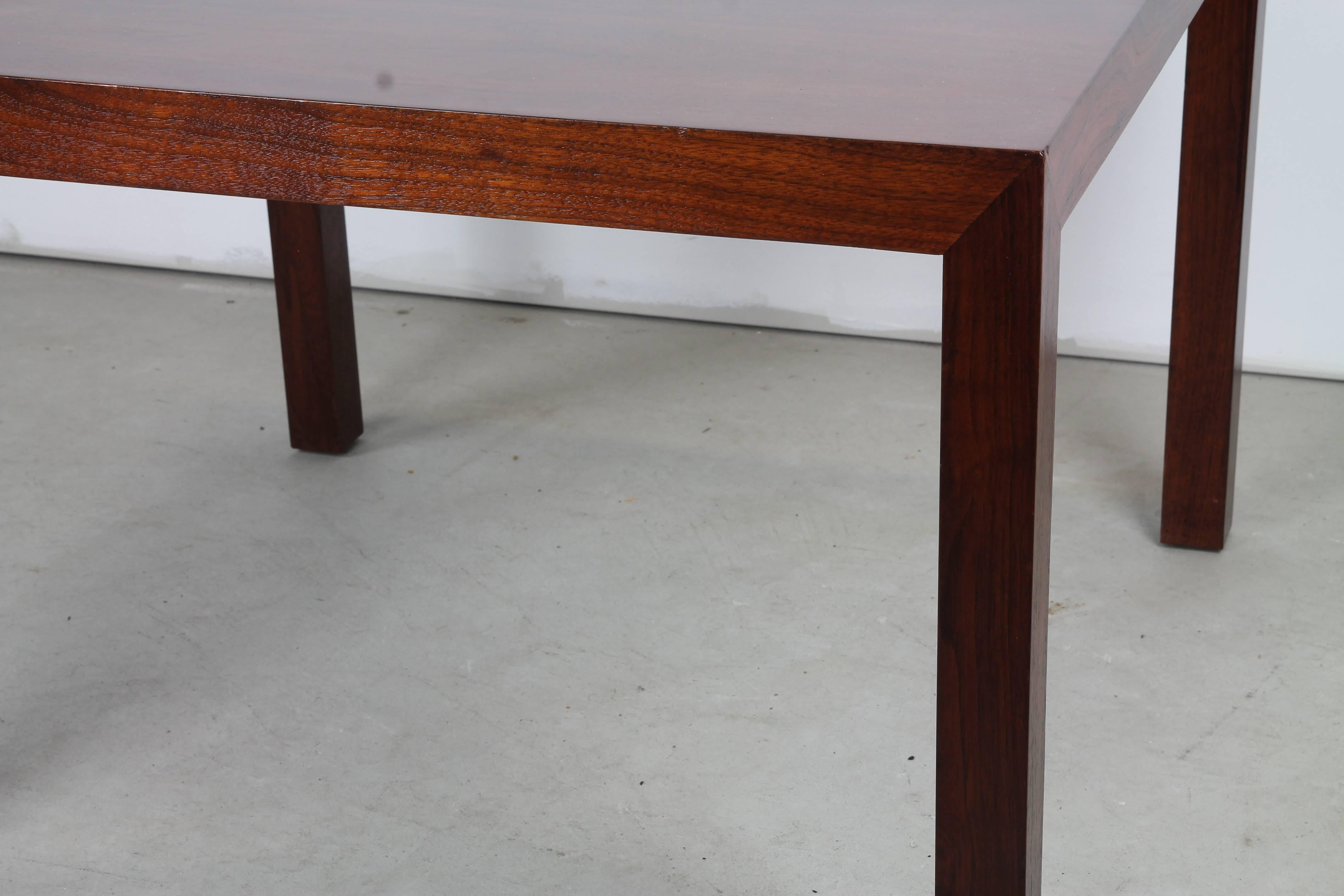 An elegant Parsons table in rich mahogany by Edward Wormley for Dunbar with original Dunbar metal tag affixed to underside.