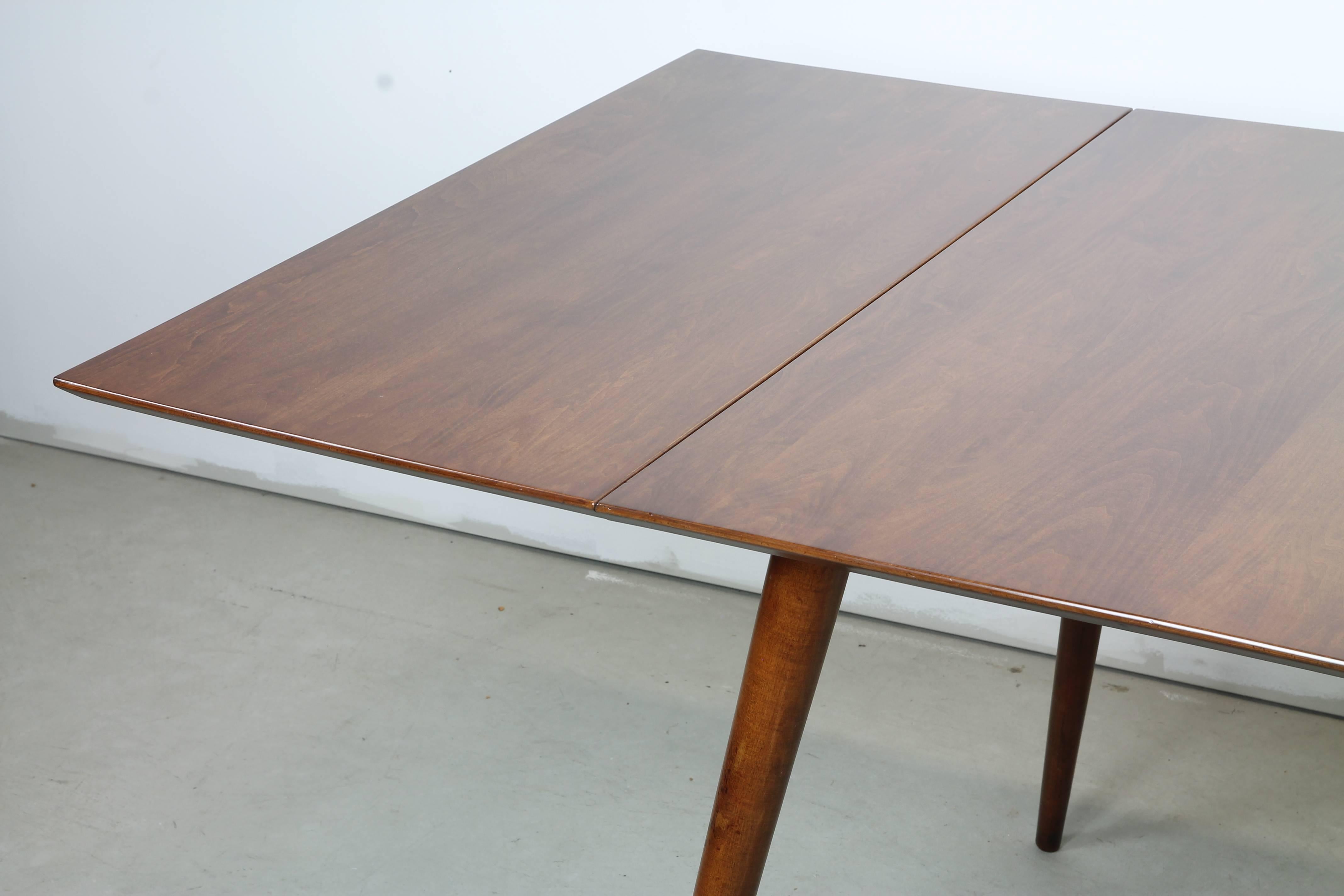 Solid dining table with two leaves by Paul McCobb as part of the Planner Group of furniture for Winchendon. A straightforward, egalitarian dining table with stunning lines and honest construction.