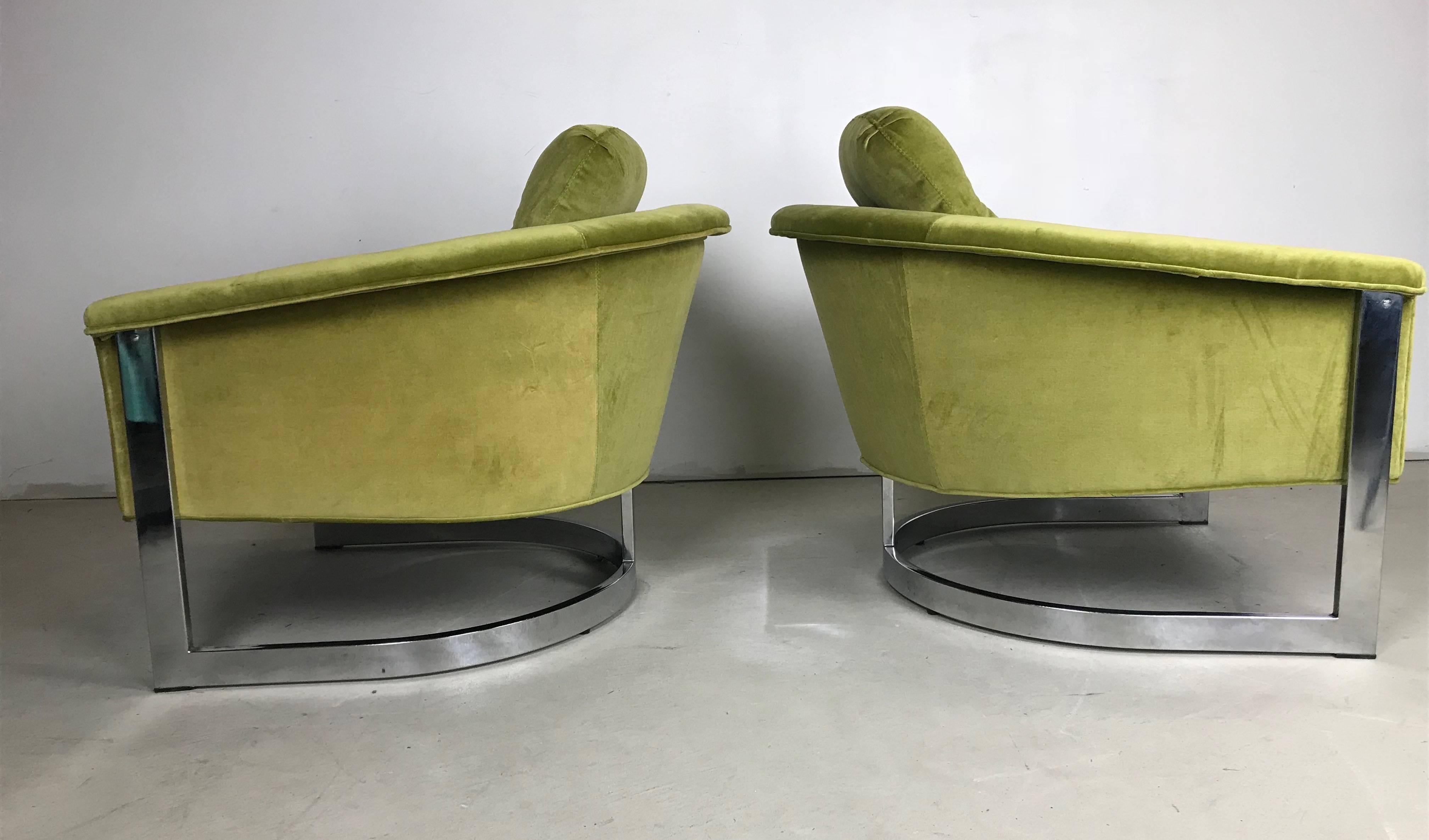 This is a lovely pair of Chromed Steel framed club chairs recently upholstered in vivid green velvet. A loose seat and back cushion with new foam make for a comfortable sit. The chromed frames show nicely but for some minor wear on the bases. A fun