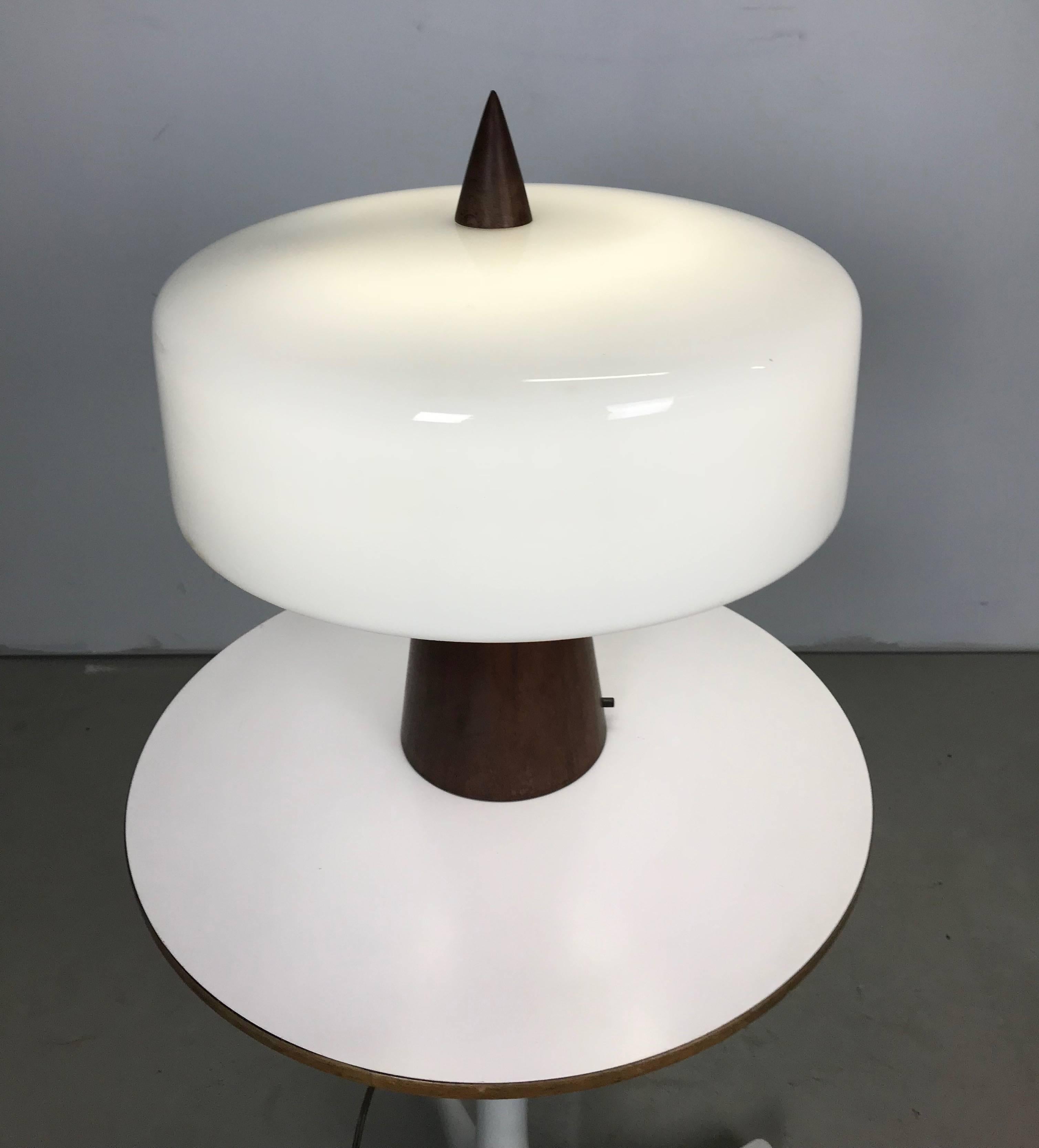 This is a one of a kind turned walnut and milk glass desk lamp. It was designed, circa 1960 by Phillip Enfield for a friend and client. It is in excellent original condition and has been owned by the same person since new. A fine and rare piece of
