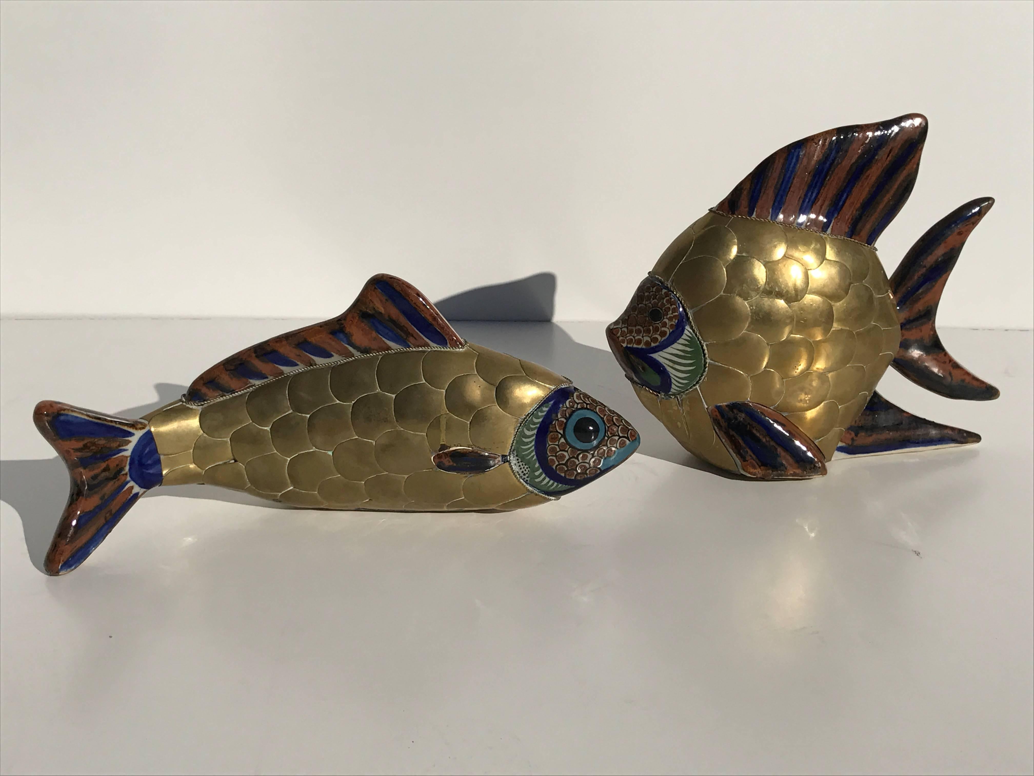 Pair of brass and ceramic fish sculptures attributed to Sergio Bustamante.
Measures: Large fish is 11