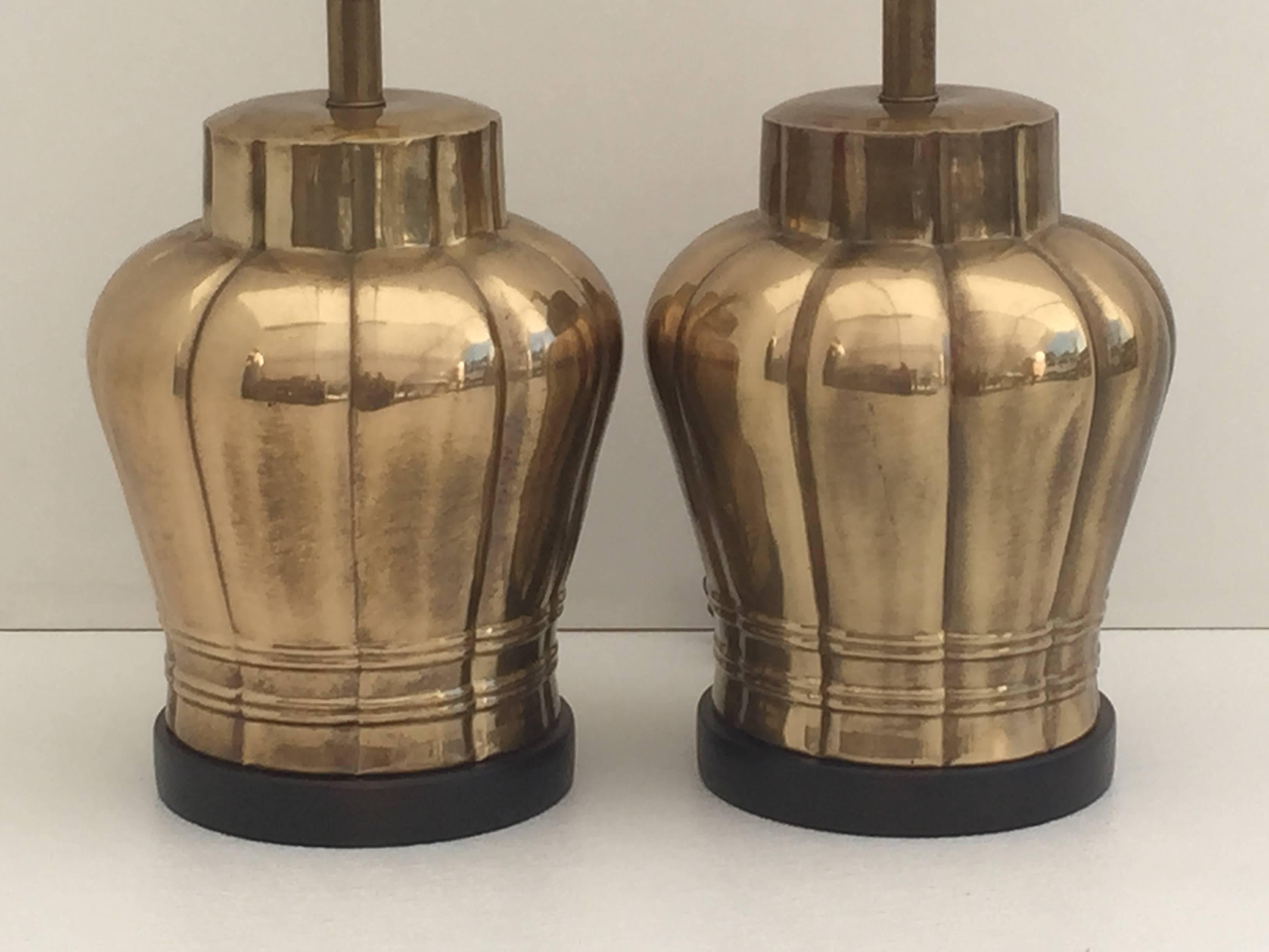 Pair of antiqued brass Frederick Cooper ginger jar urn lamps on darkwood base.