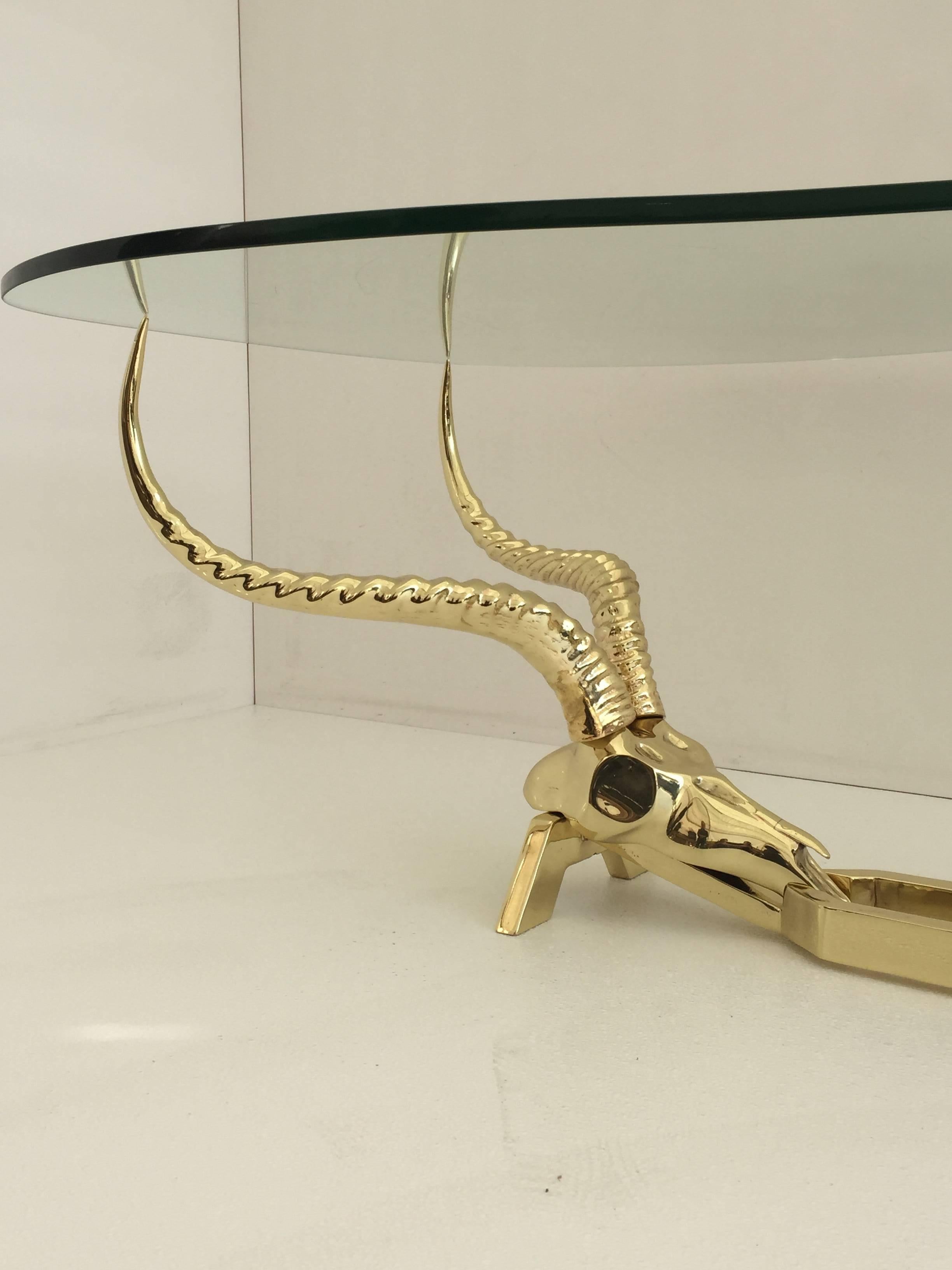 Brass ibex or antelope coffee table by Fondica, France.
Base is 15" by 41" by 16.5" high.
It's made of brass-plated steel.