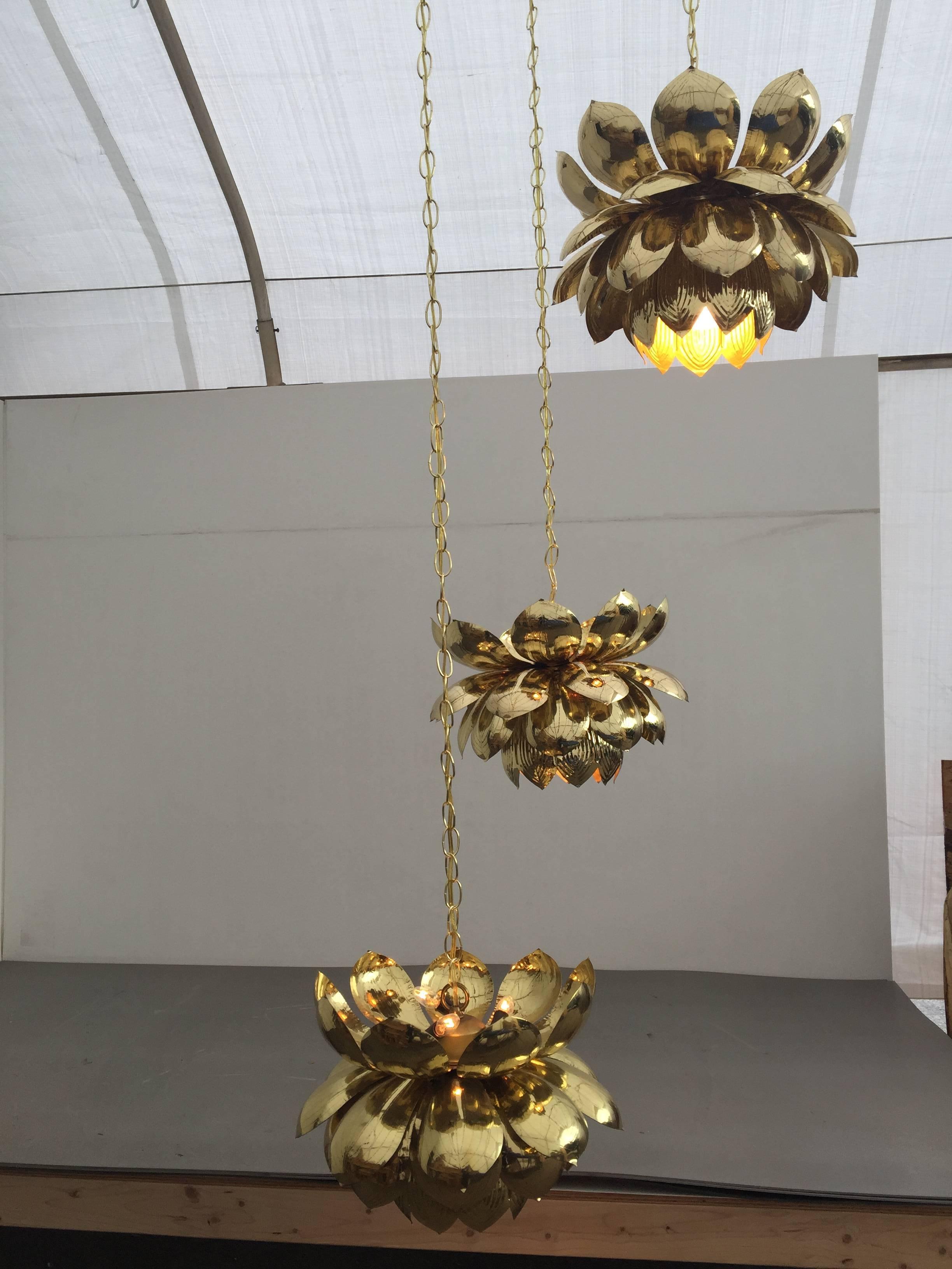 Absolutely stunning massive brass three large lotus chandelier by Feldman.
These chandeliers originally come in small lotus three and six pendants (we have six pendant version) We custom-made the brass ceiling plate and attached three original large