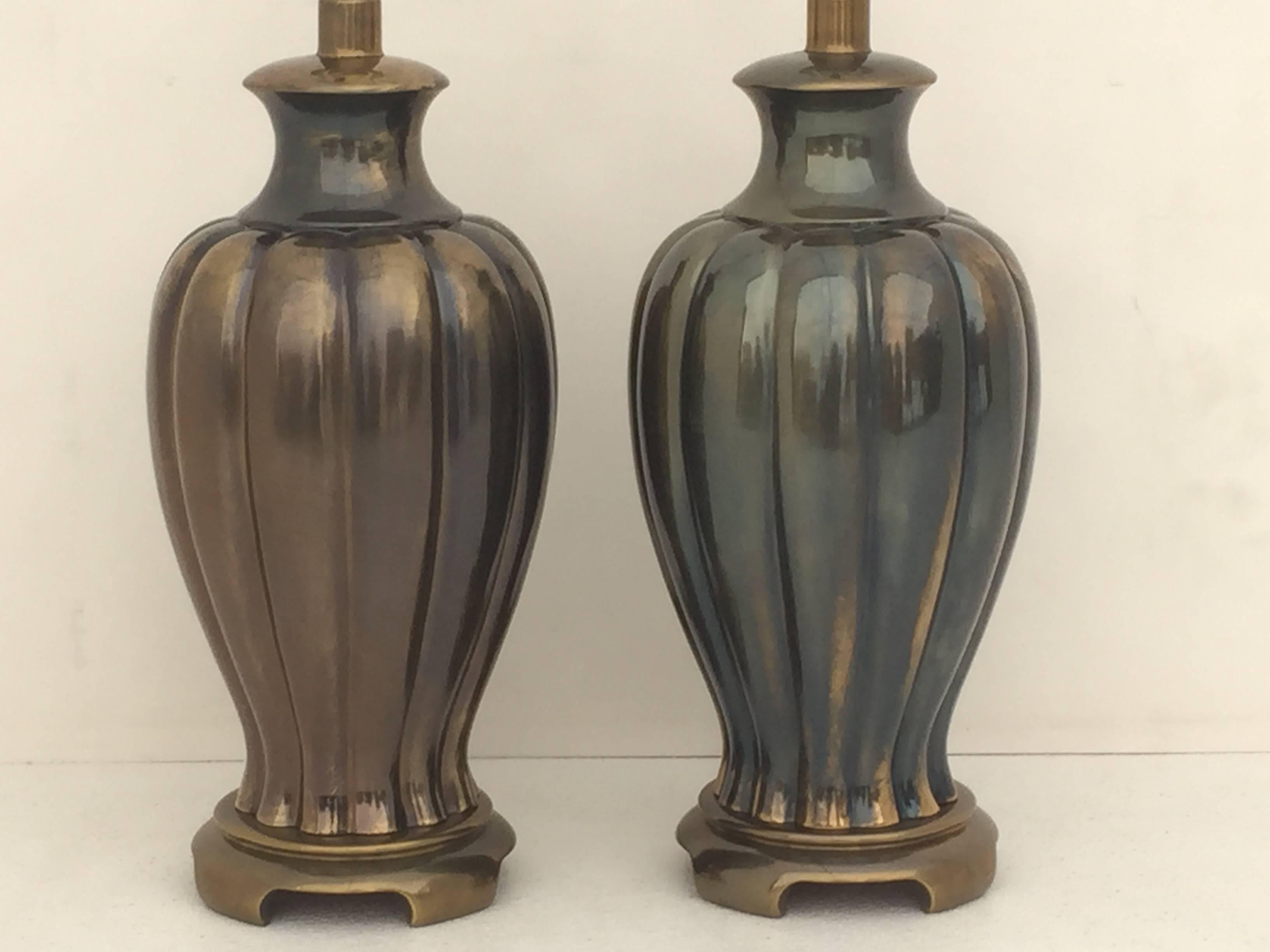 Pair of ginger jar table lamps in antique bronze finish.